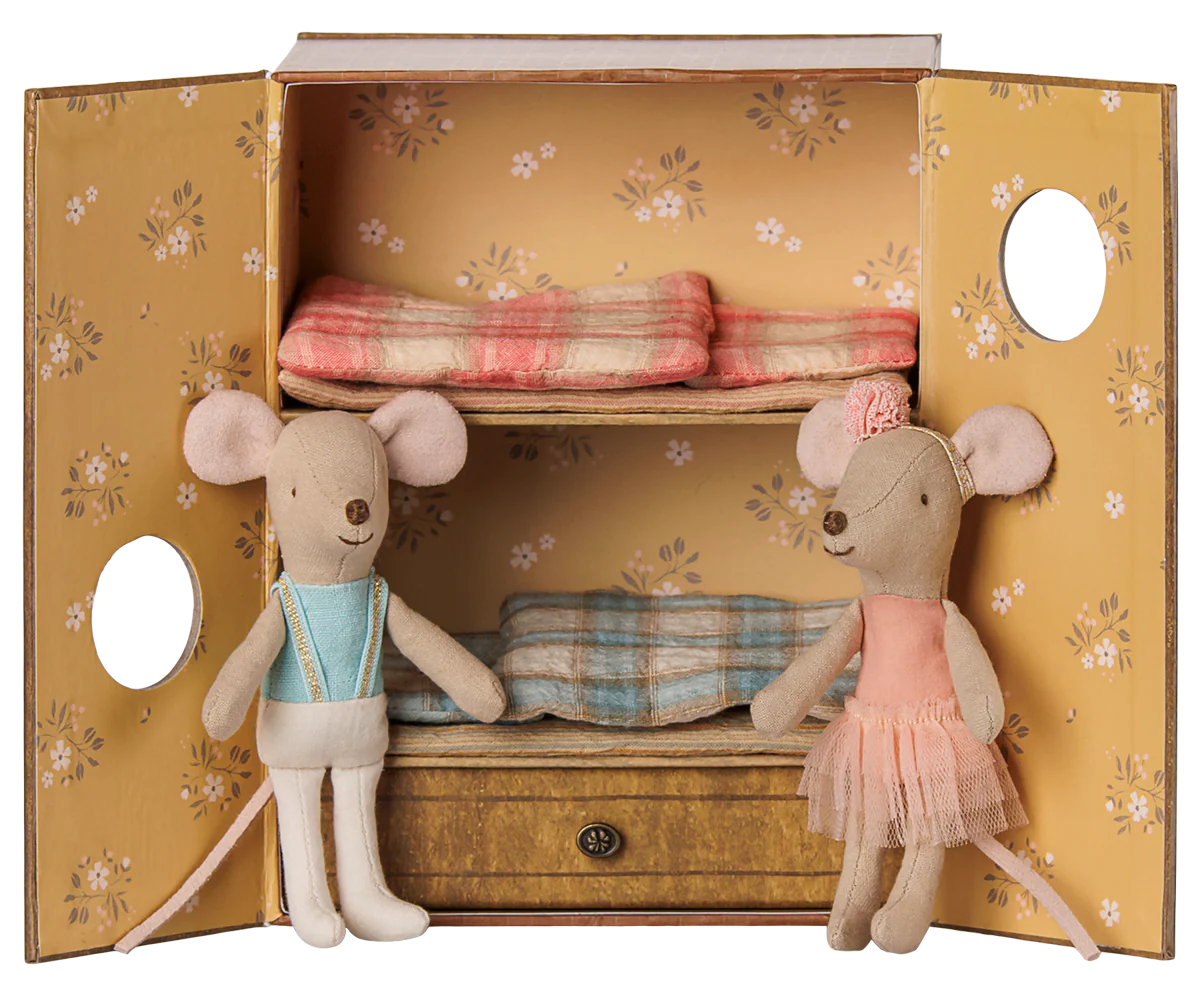 Maileg ballet mice siblings in a dance studio, wearing tutus and dance attire, with a colorful and playful background.