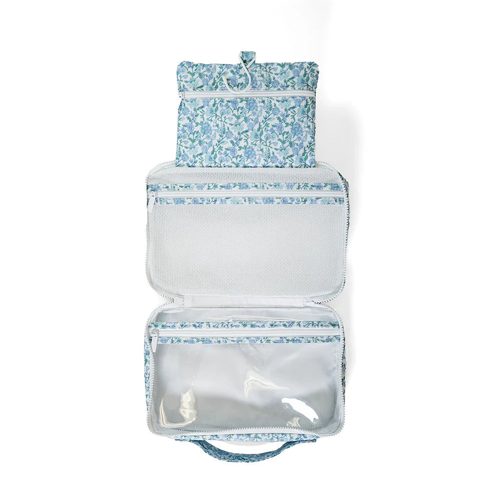 Two hanging toiletry bags from TRVL Designs' Bundle Up 2 Hamptons Floral collection, featuring floral patterns and hanging hooks.