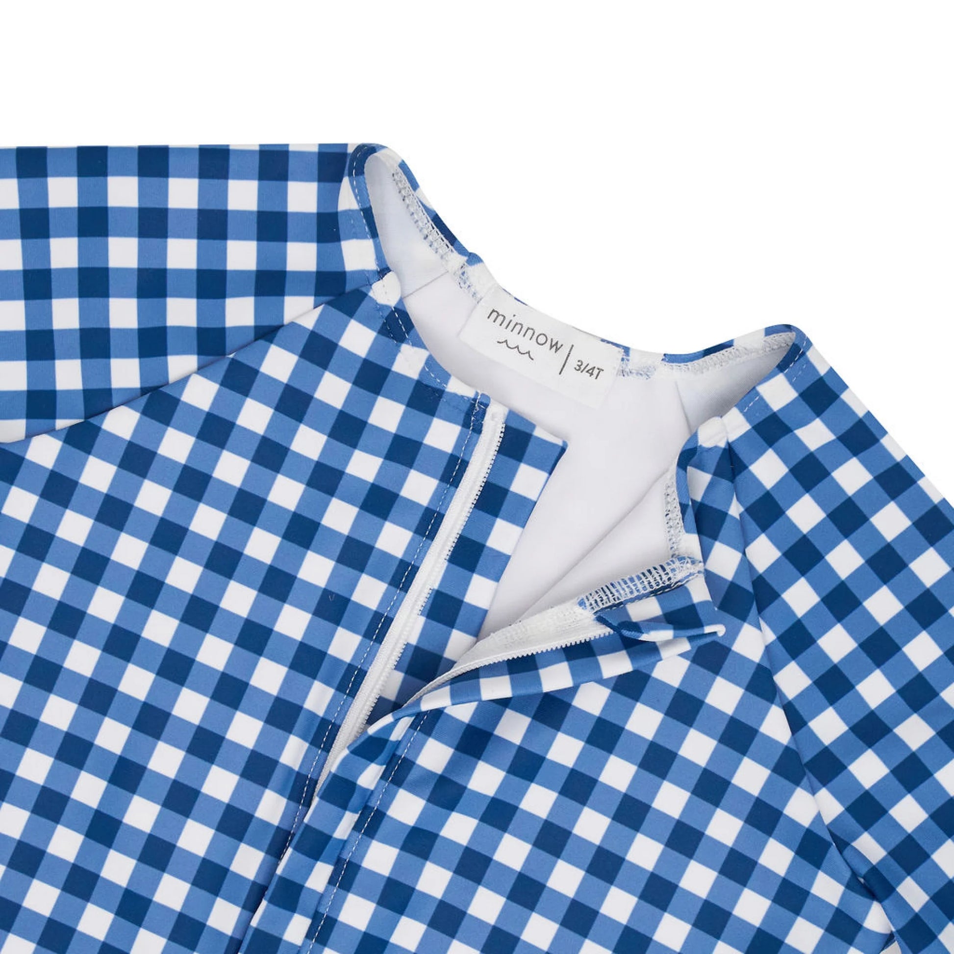Girls navy gingham front zip rashguard one-piece by Minnow, featuring long sleeves and a comfortable, stylish design.