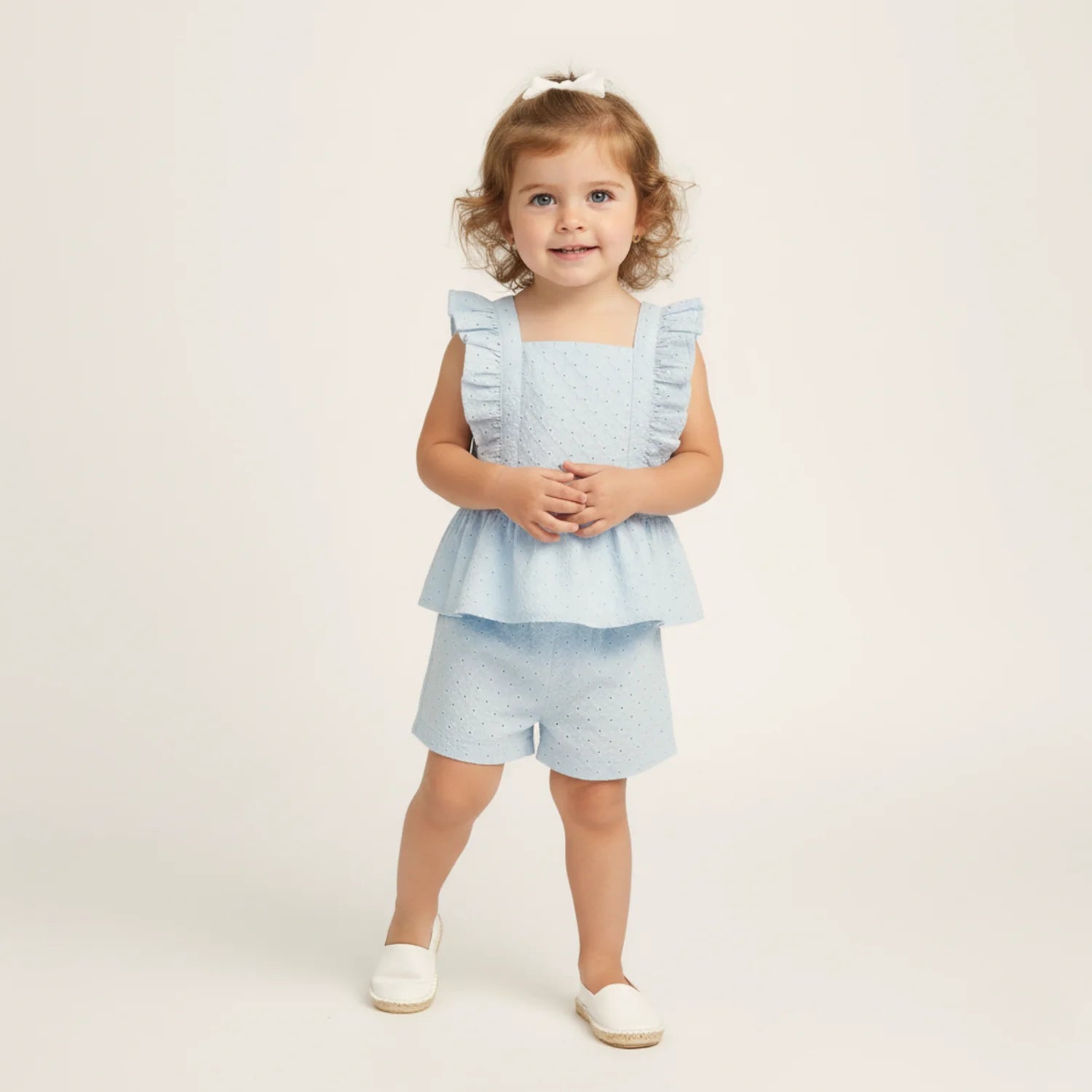 Light blue eyelet flutter top and shorts set by MakeMake, featuring delicate eyelet details and a breezy, stylish design.