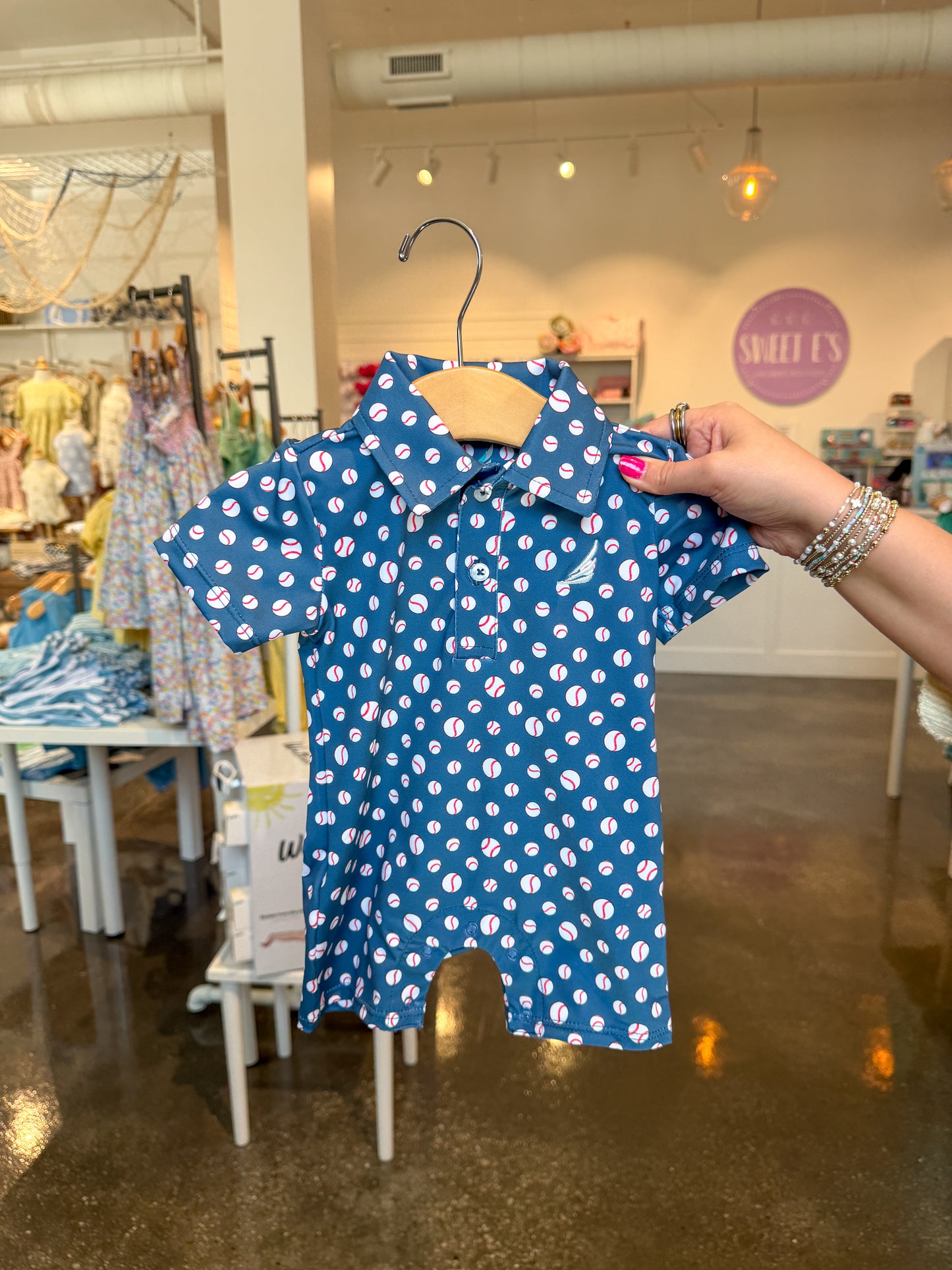 Navy baseball print Banks performance polo romper by Coolybri, featuring short sleeves and a casual, sporty design.