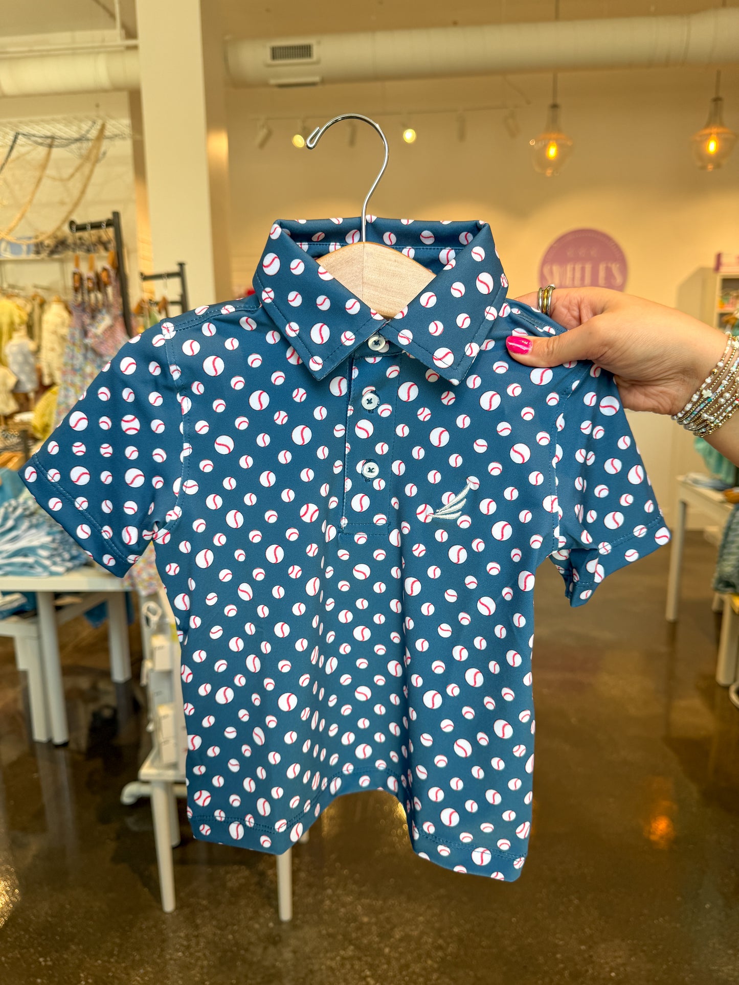Navy baseball print Miles Performance short-sleeve polo shirt by Coolybri, featuring a classic baseball pattern and breathable fabric.