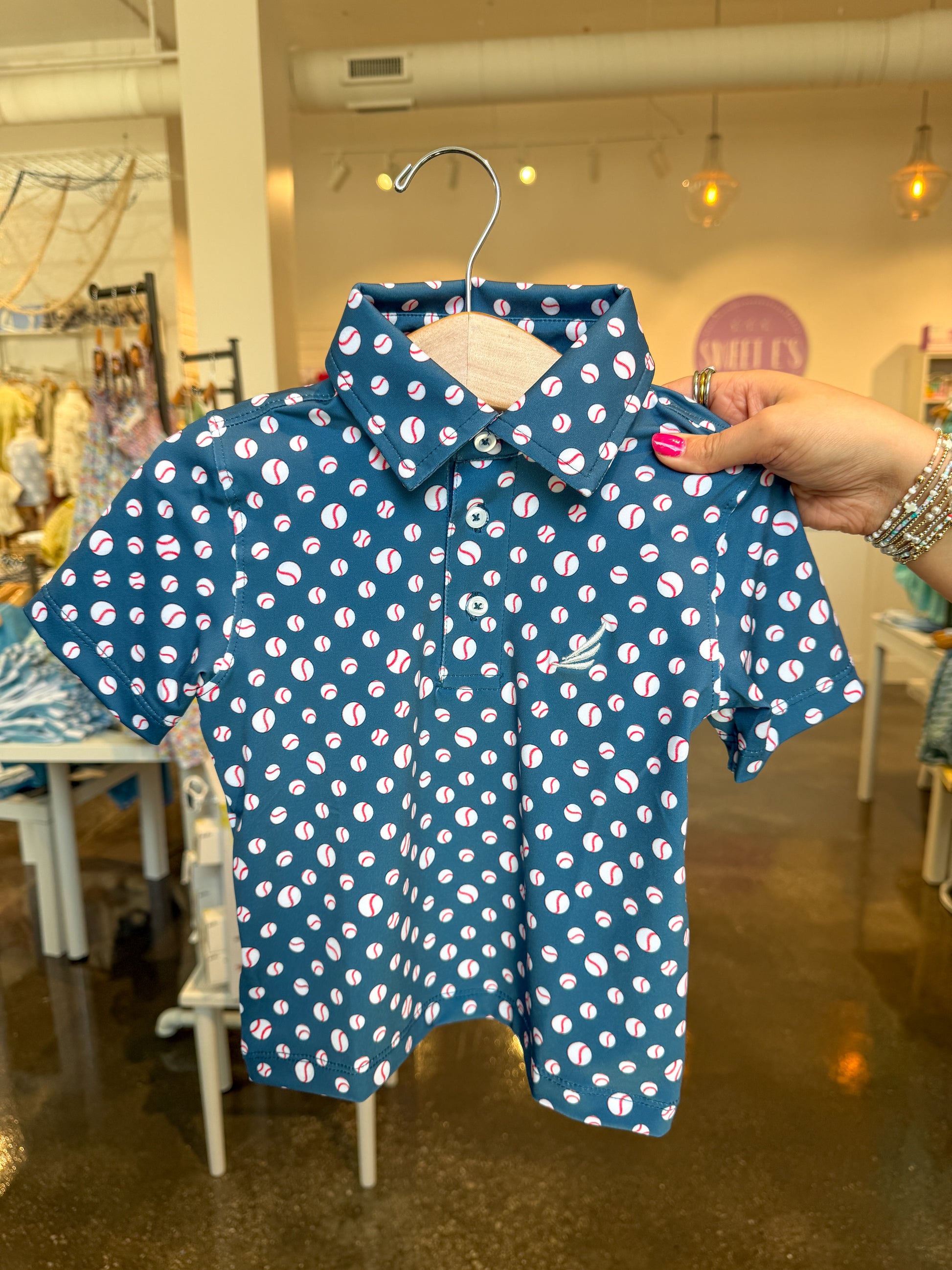 Navy baseball print Miles Performance short-sleeve polo shirt by Coolybri, featuring a classic baseball pattern and breathable fabric.