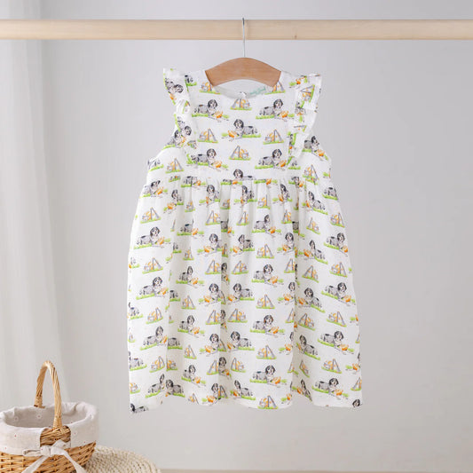 Nola Tawk Mascot Mania Tennessee organic muslin dress displayed on a hanger with colorful mascot patterns.