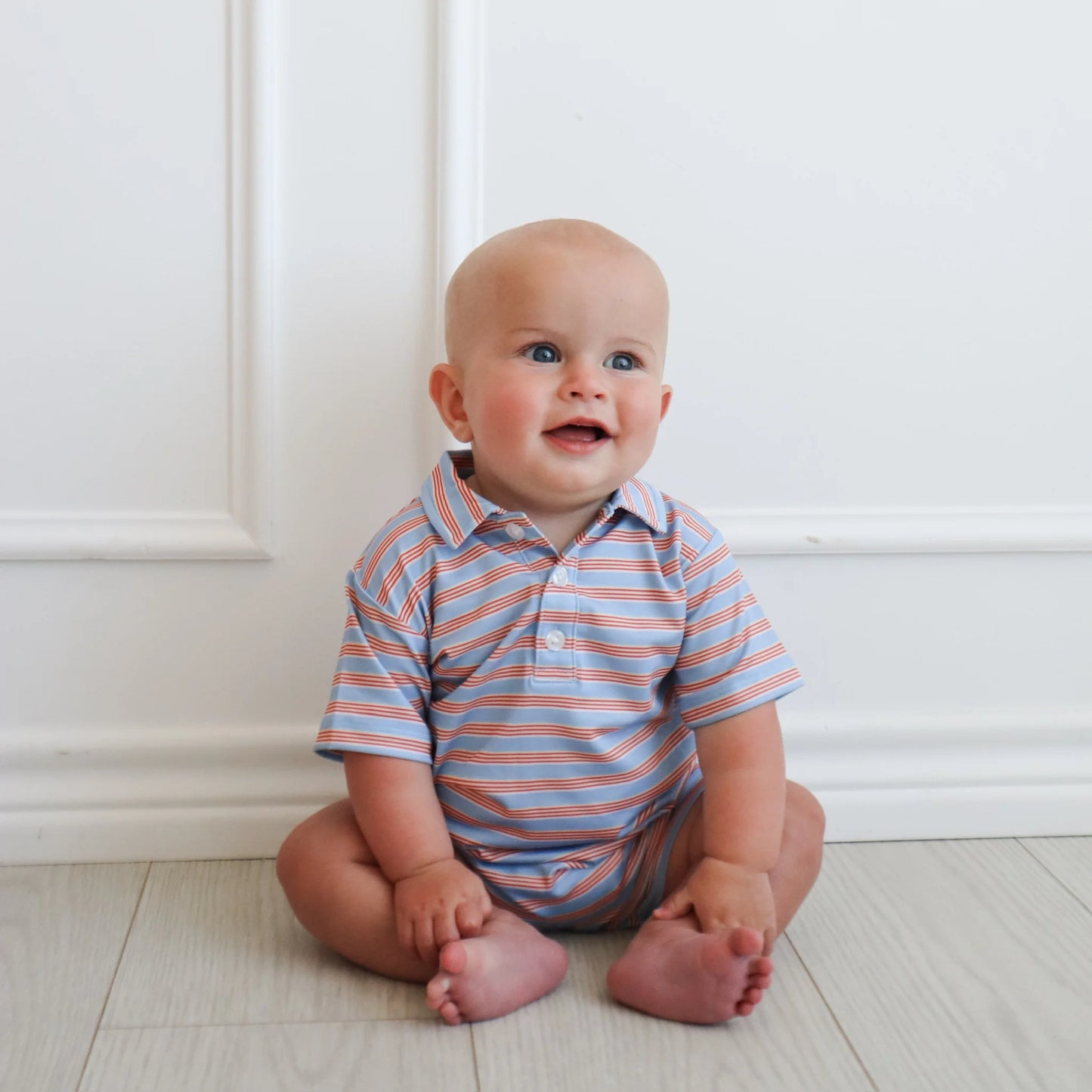 Hollis Baker red and blue stripe Knox romper for infants, featuring a comfortable sleeveless design and playful striped pattern.