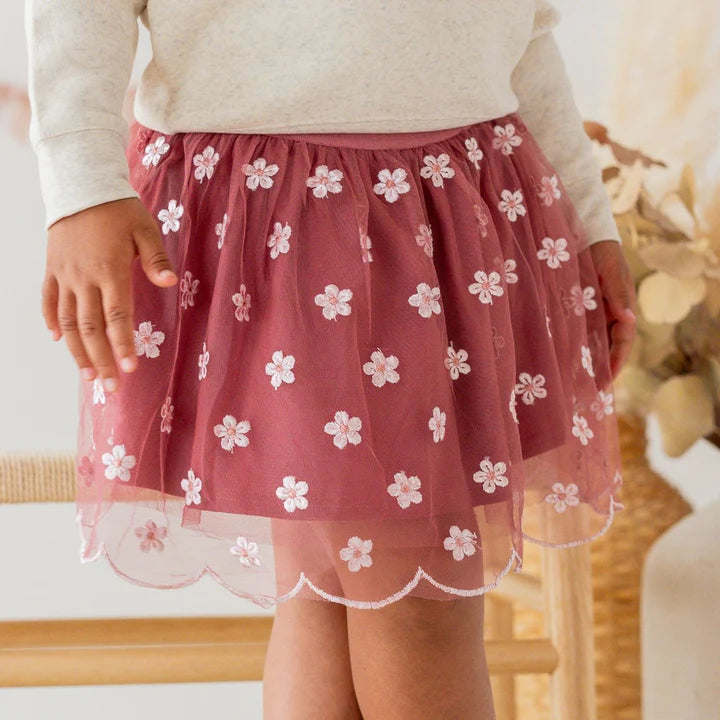Model wearing a Berry Floral Embroidered Tutu Skirt by Sweet Wink, featuring colorful floral embroidery and a layered tulle design.