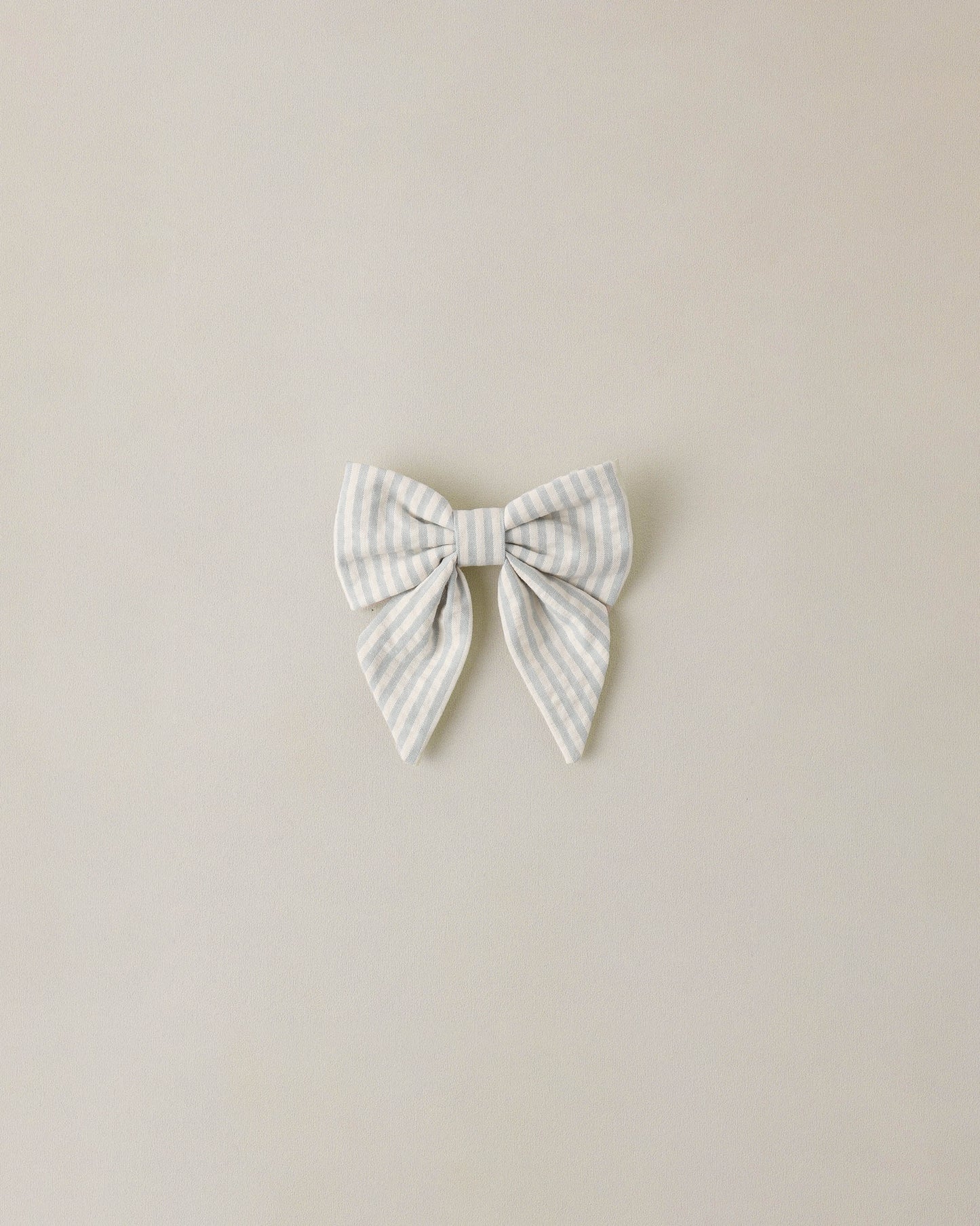 Noralee Sky Stripe Norah Bow hair accessory with blue and white striped fabric, decorative bow for girls' fashion.