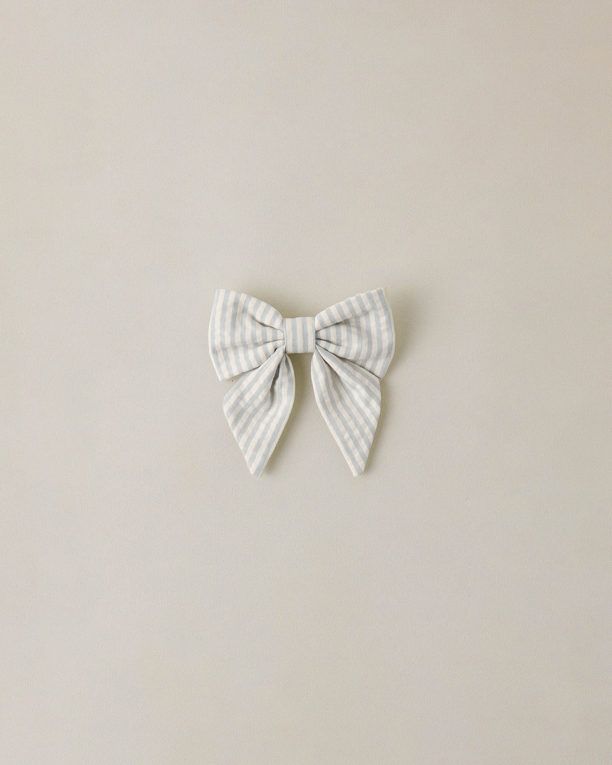 Noralee Sky Stripe Norah Bow hair accessory with blue and white striped fabric, decorative bow for girls' fashion.