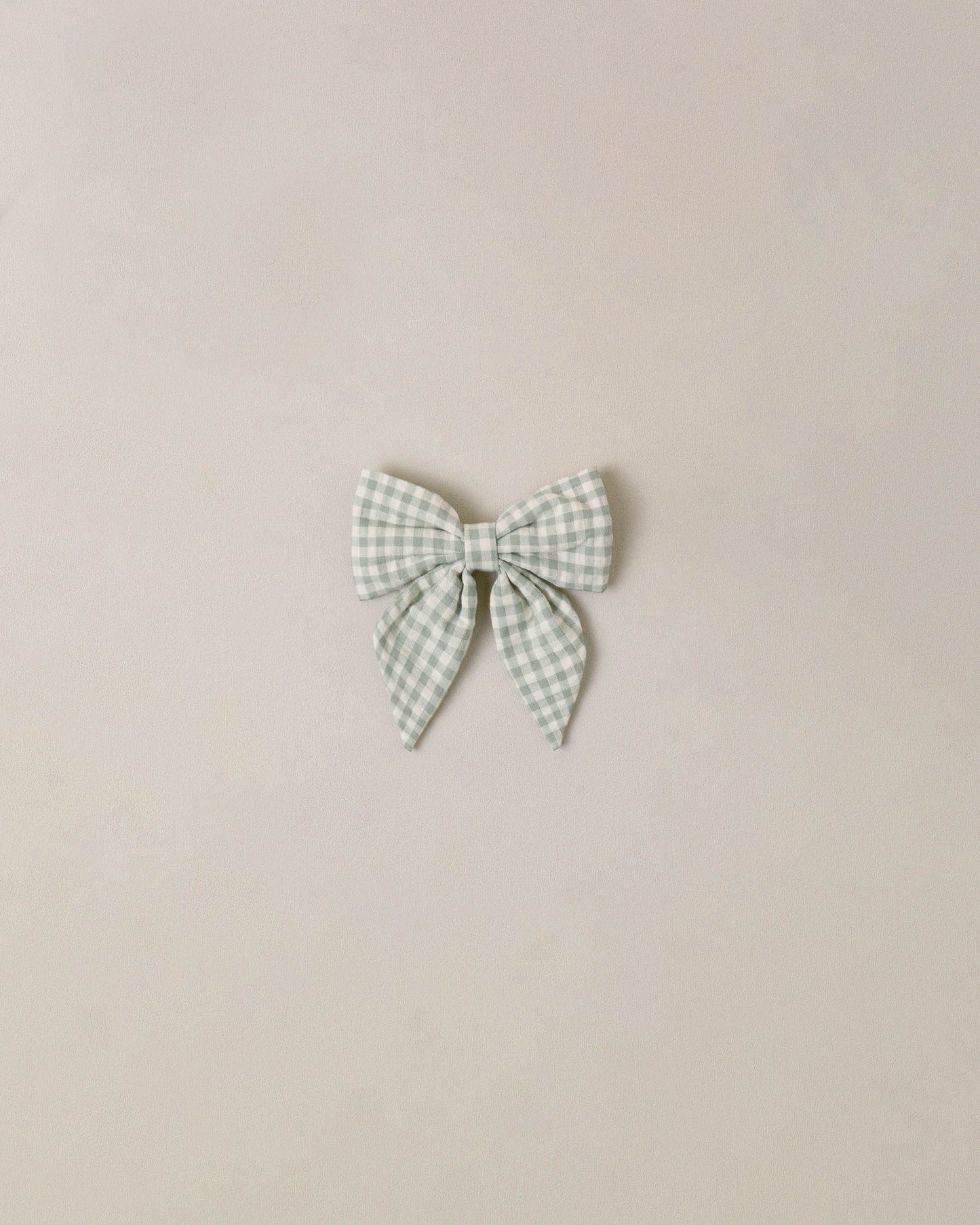 Noralee Eucalyptus Check Norah Bow, a stylish hair accessory featuring a green and white check pattern with a decorative bow.