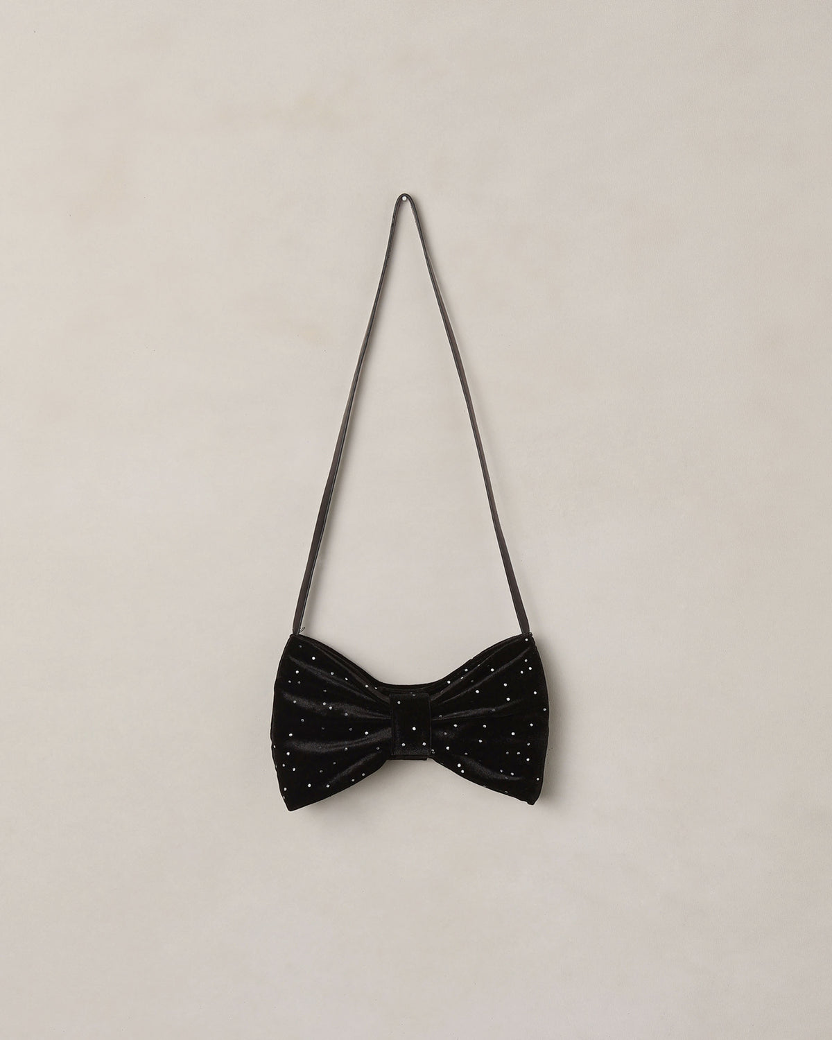 Black rhinestone bow purse by Noralee, featuring sparkling rhinestones and a chic bow design, shown in close-up detail.