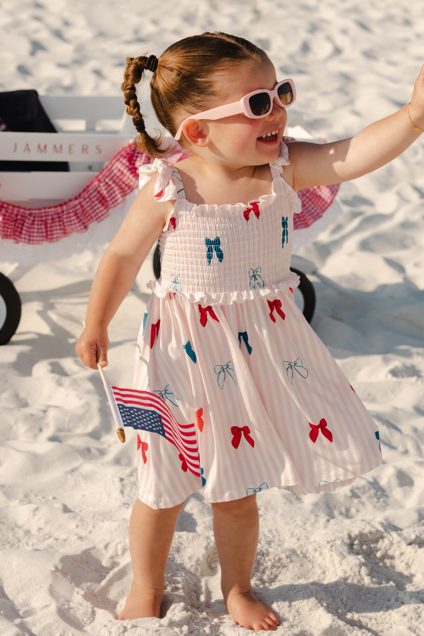 In My Jammers Liberty Bow Smocked Twirl Dress with a bow detail and ruffled hem, perfect for little girls' special occasions.