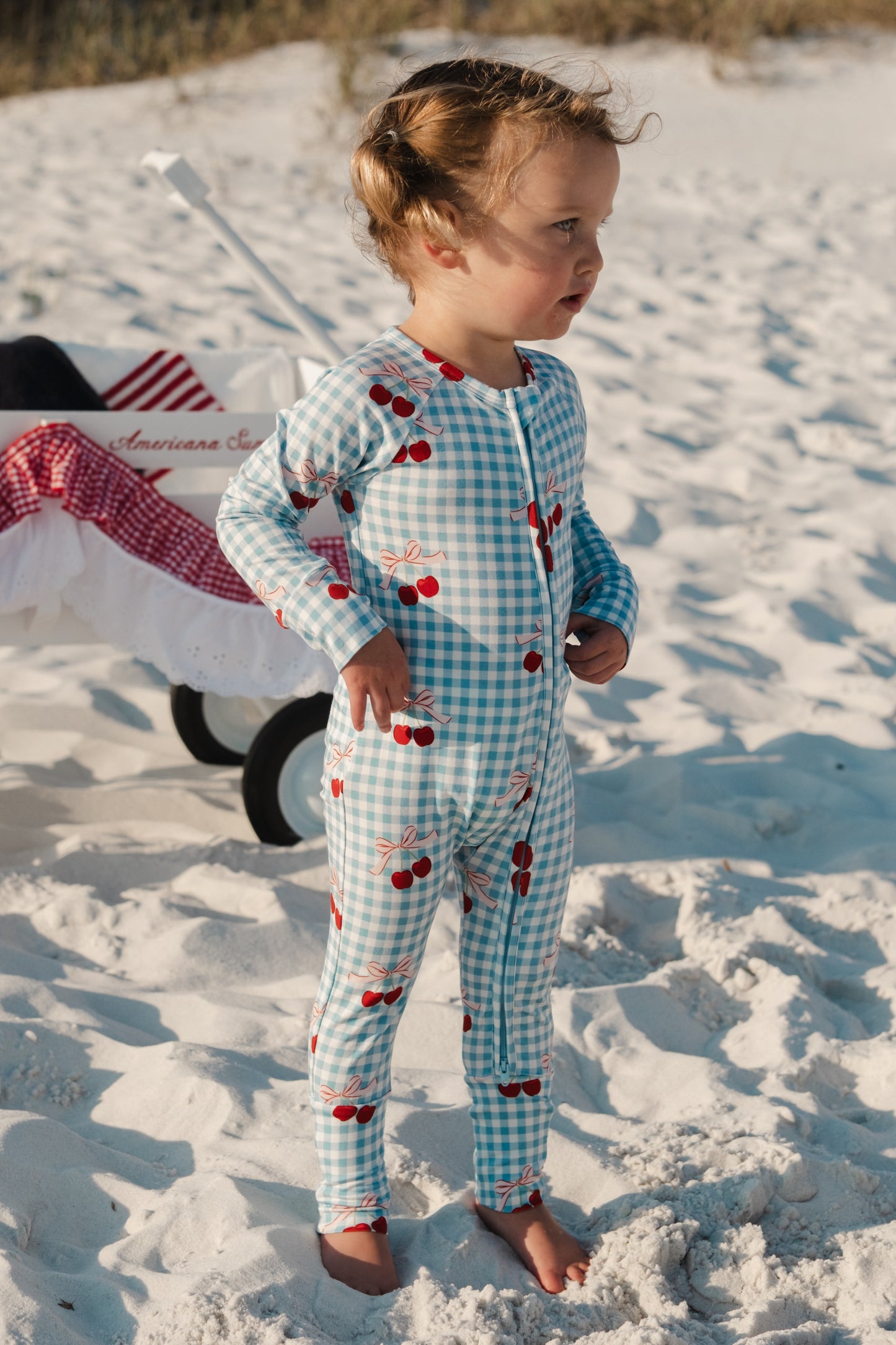 In My Jammers Little Cherry Zipper Romper shown in pink with cherry print, front zipper closure, and short sleeves.
