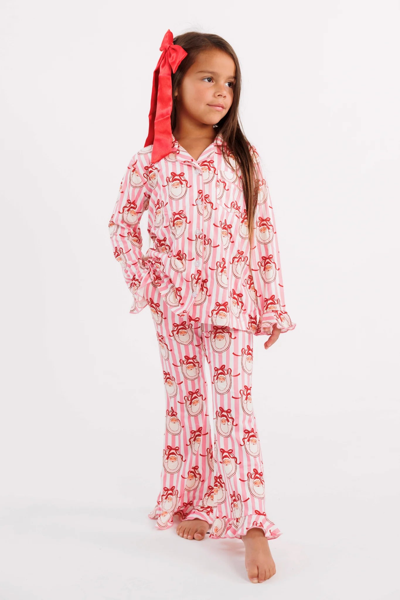 Pink Santa Claus Lane kids' long sleeve ruffle flare set by In My Jammers, featuring a festive pink and white design with button-up details.