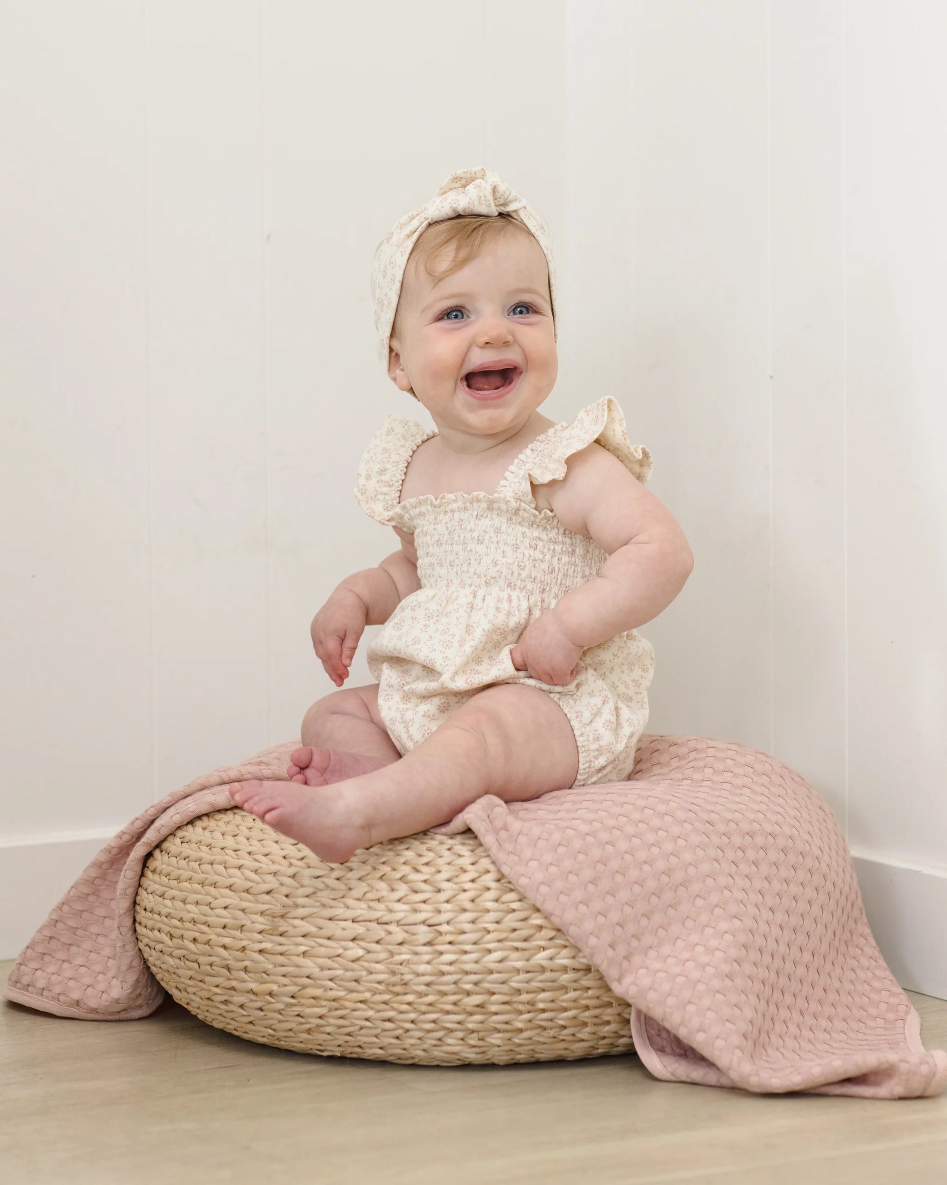 Quincy Mae Ditsy Smocked Ruffle Sleeve Romper in lightweight fabric, featuring a floral pattern and ruffle sleeve design.
