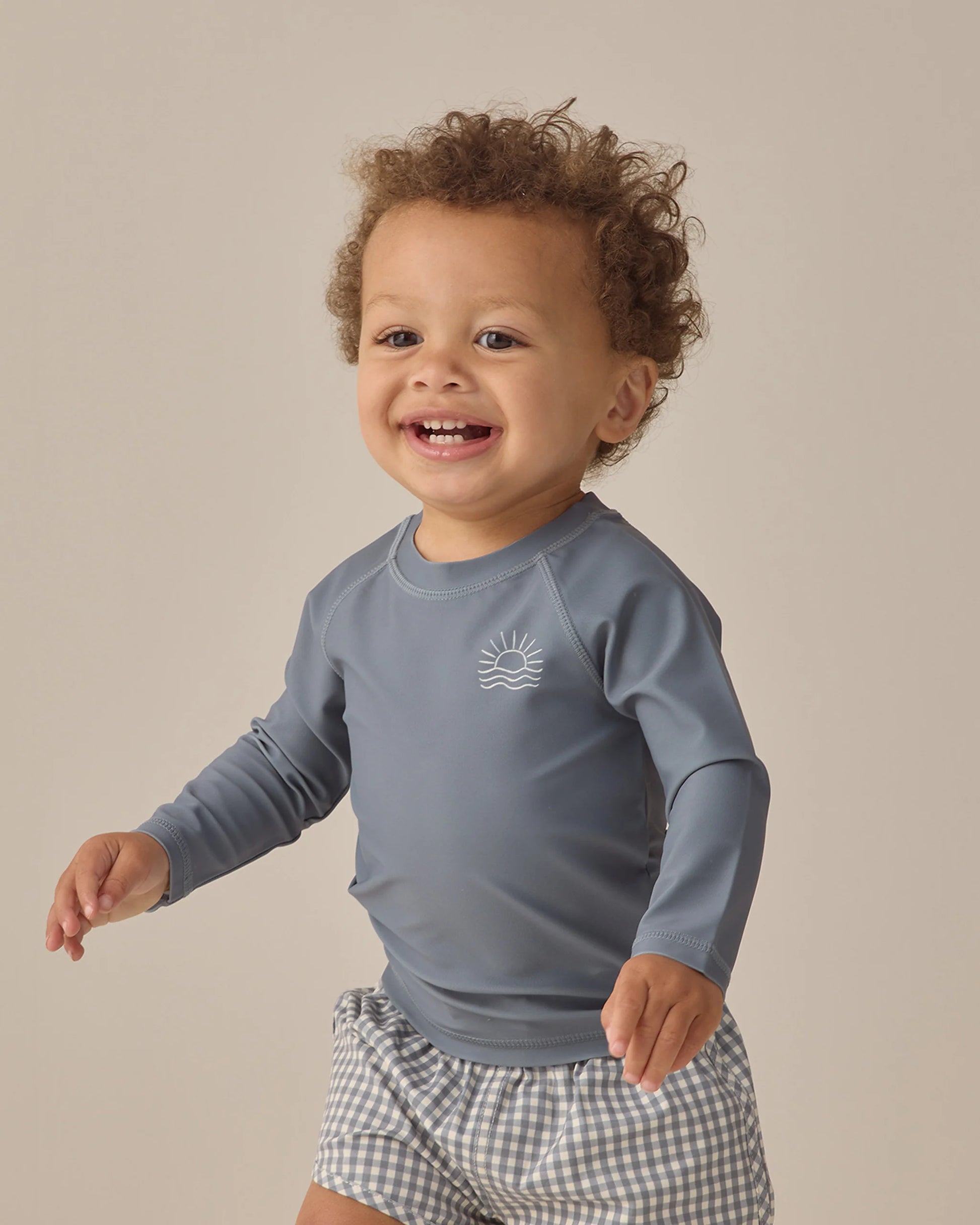 Ocean Gingham boys swimshort by Quincy Mae featuring blue and white gingham pattern and elastic waistband for comfortable fit.