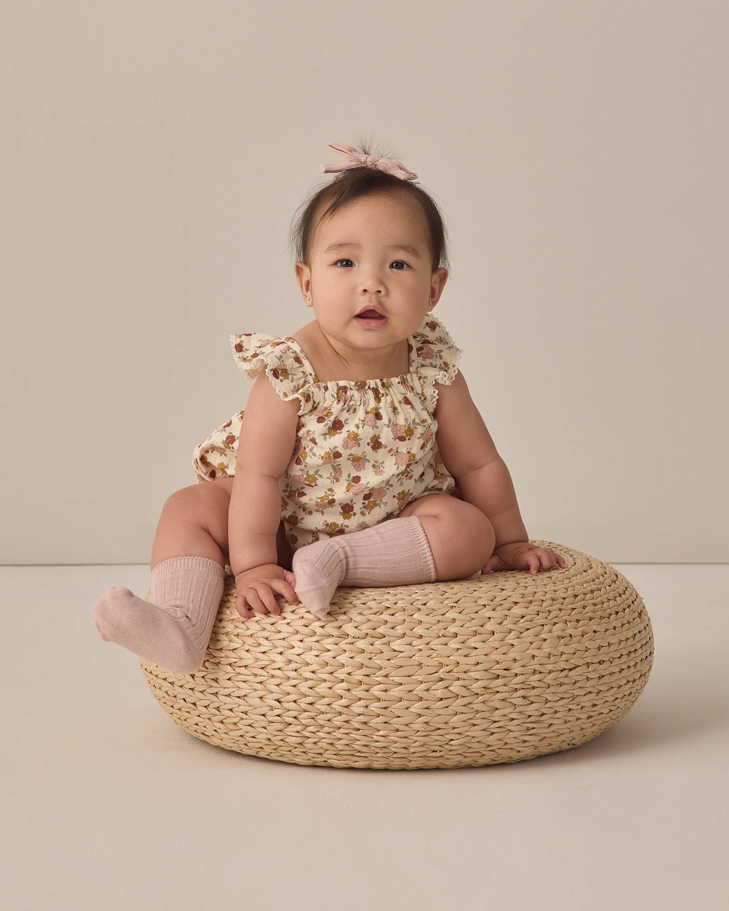 Quincy Mae Bloom Bonnie romper for babies, featuring soft fabric and floral print, displayed on a neutral background.