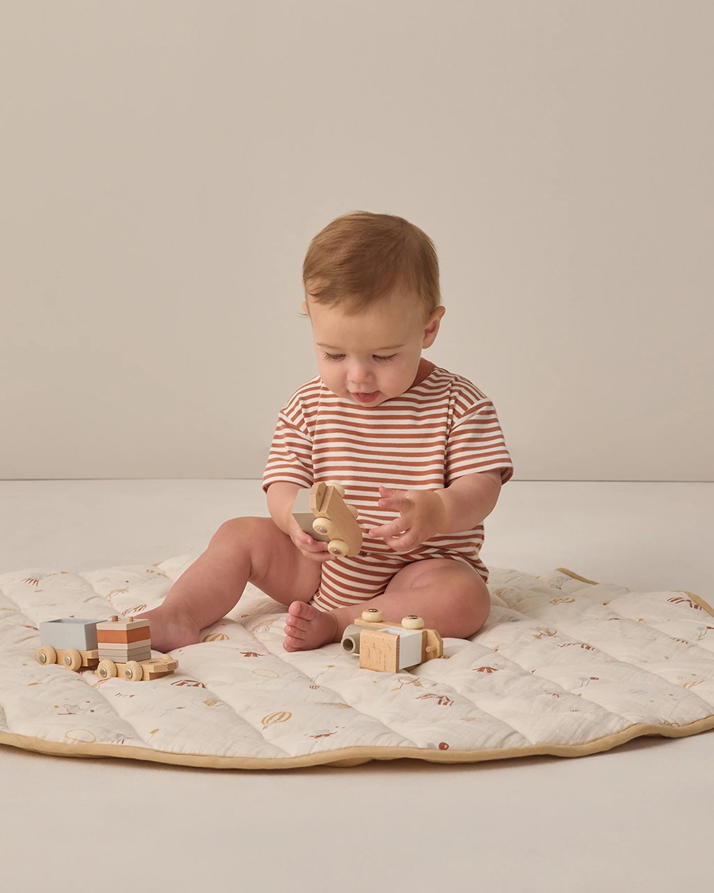 Quincy Mae Poppy Stripe Relaxed Bubble Romper featuring colorful striped fabric and comfortable fit for babies.