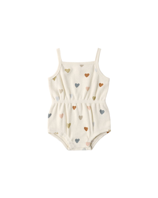 Natural-colored Quincy Mae confetti hearts waffle cinch romper for babies, featuring a soft, textured fabric and cinched waist design.