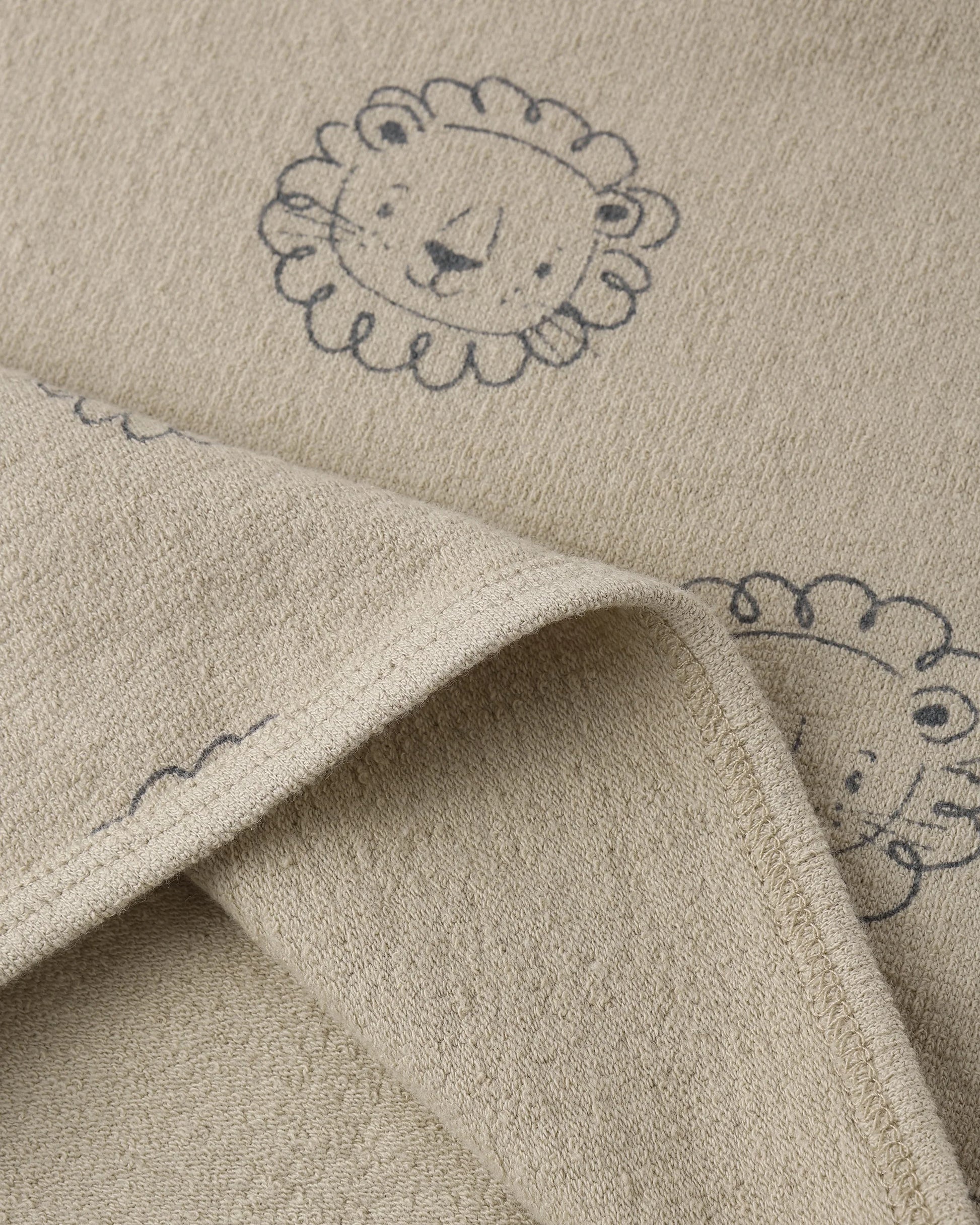 Lion Darla Dress by Quincy Mae, oatmeal-colored dress with lion print and ruffled details, suitable for young children.