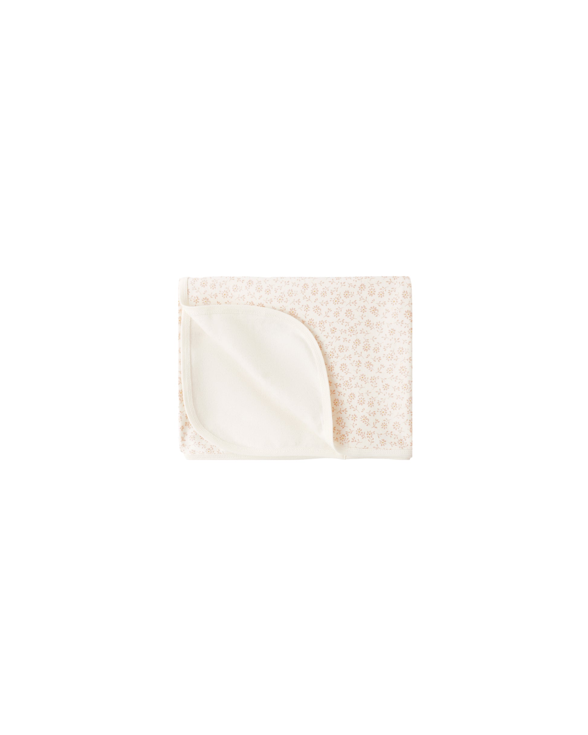 Cream-colored Ditsy Swaddle by Quincy Mae featuring a delicate floral pattern, soft and breathable fabric for newborn comfort.