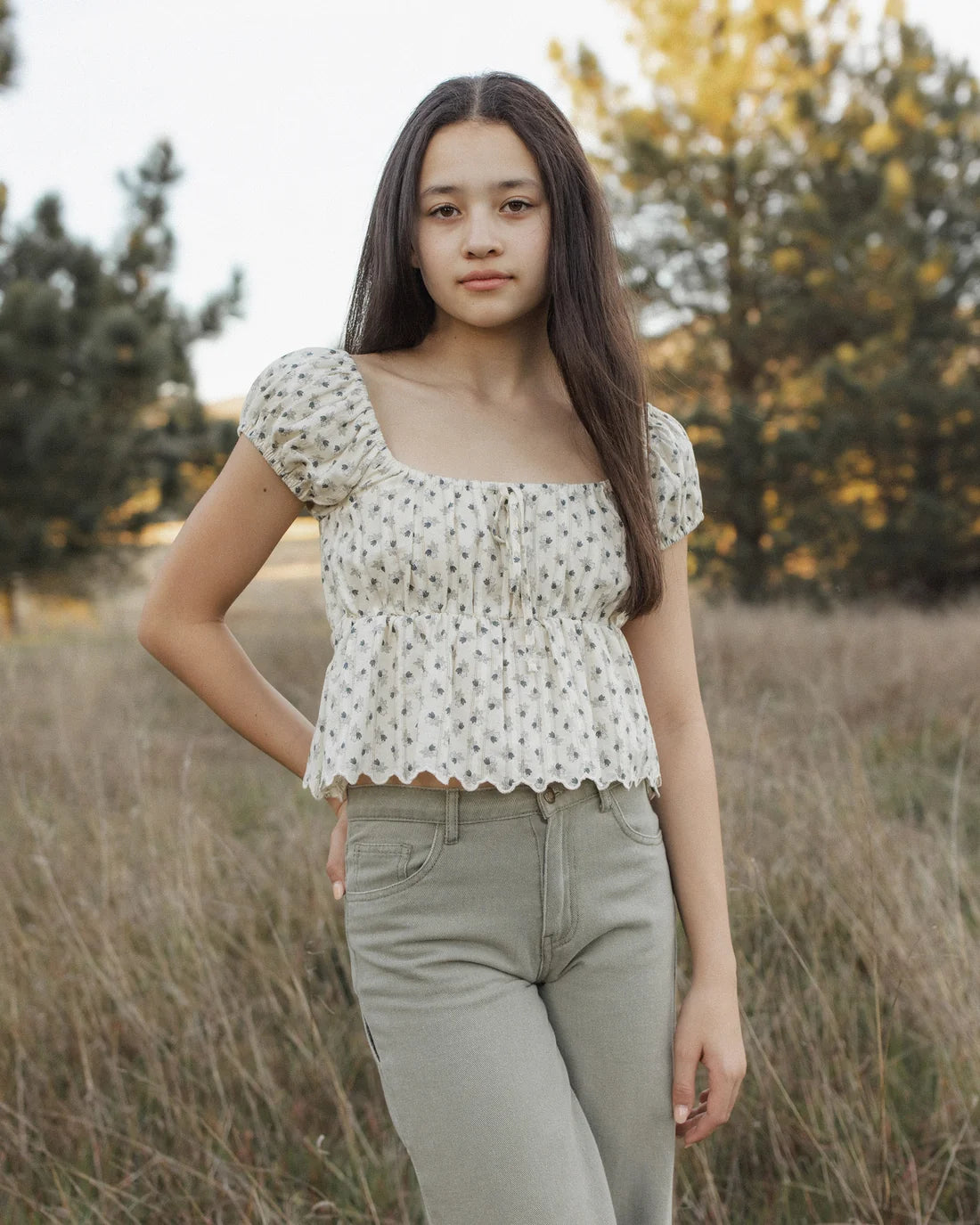 Teen vintage Fleur Rylan top by Rylee & Cru, featuring floral pattern and soft fabric, worn by a girl in a casual outdoor setting.