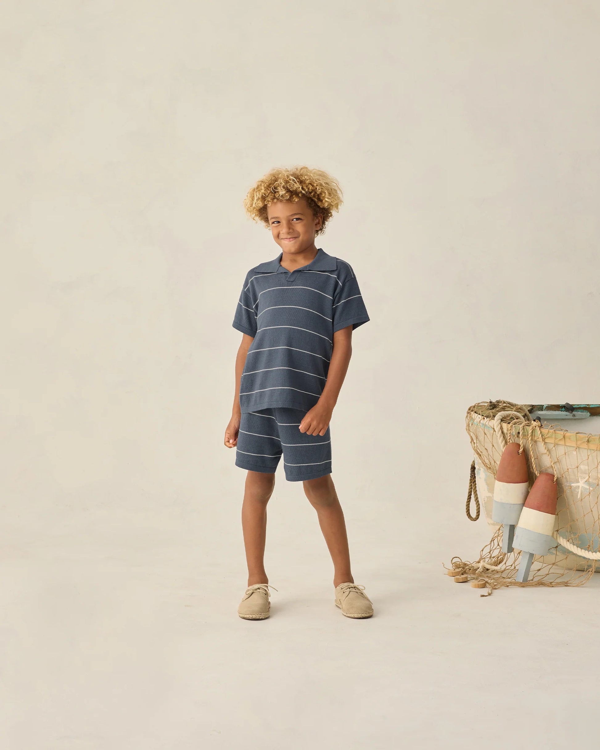 Navy stripe Chandler knit polo shirt by Rylee & Cru, featuring a classic collar, short sleeves, and ribbed knit texture.