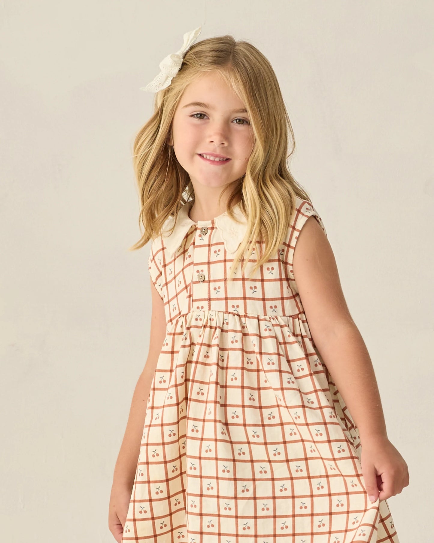 Cherry check collared babydoll dress by Rylee & Cru, featuring a playful print and a relaxed fit with a button front and short sleeves.