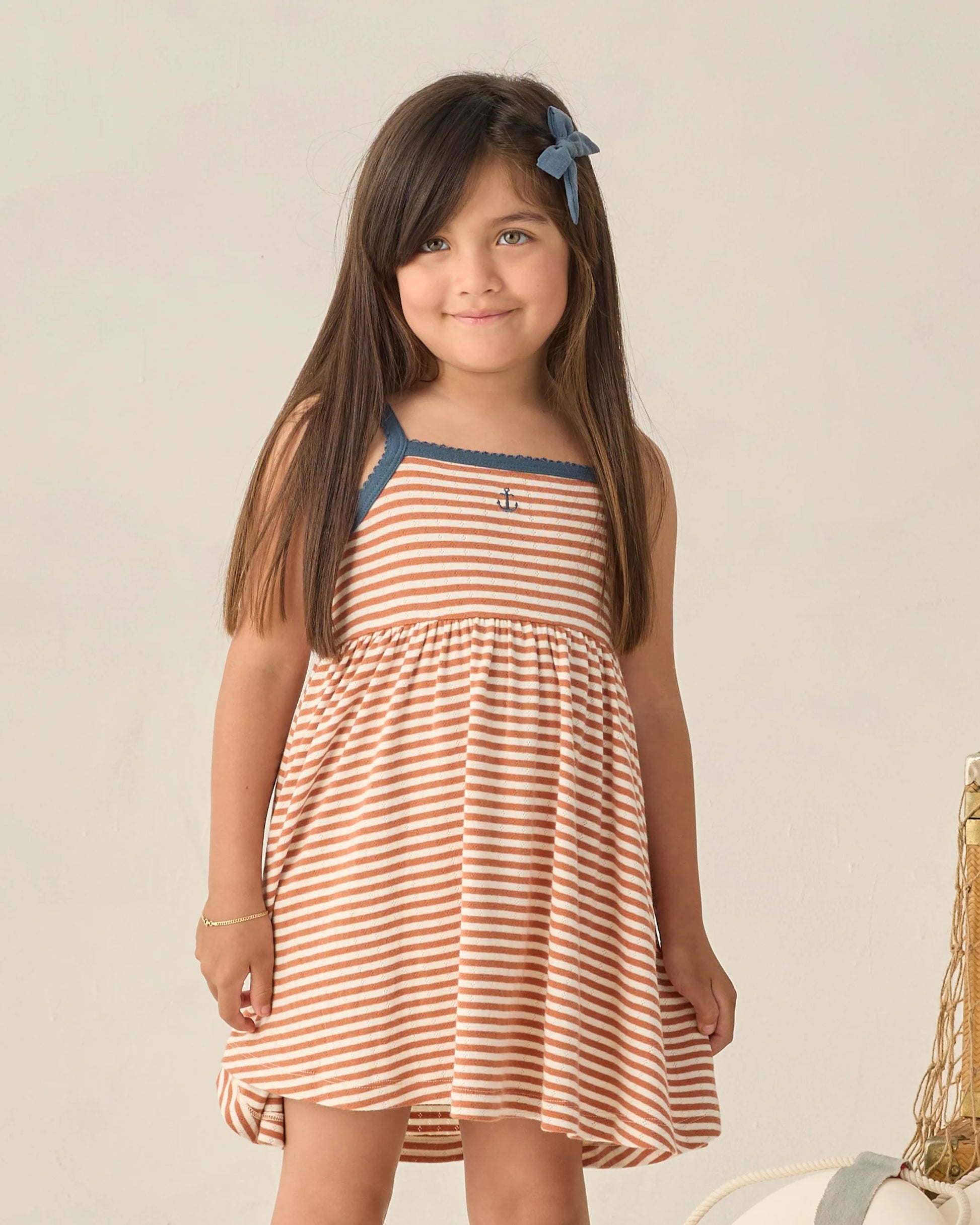 Rylee & Cru Poppy Stripe Lea Dress for girls with colorful striped pattern and ruffle details, displayed on a hanger.