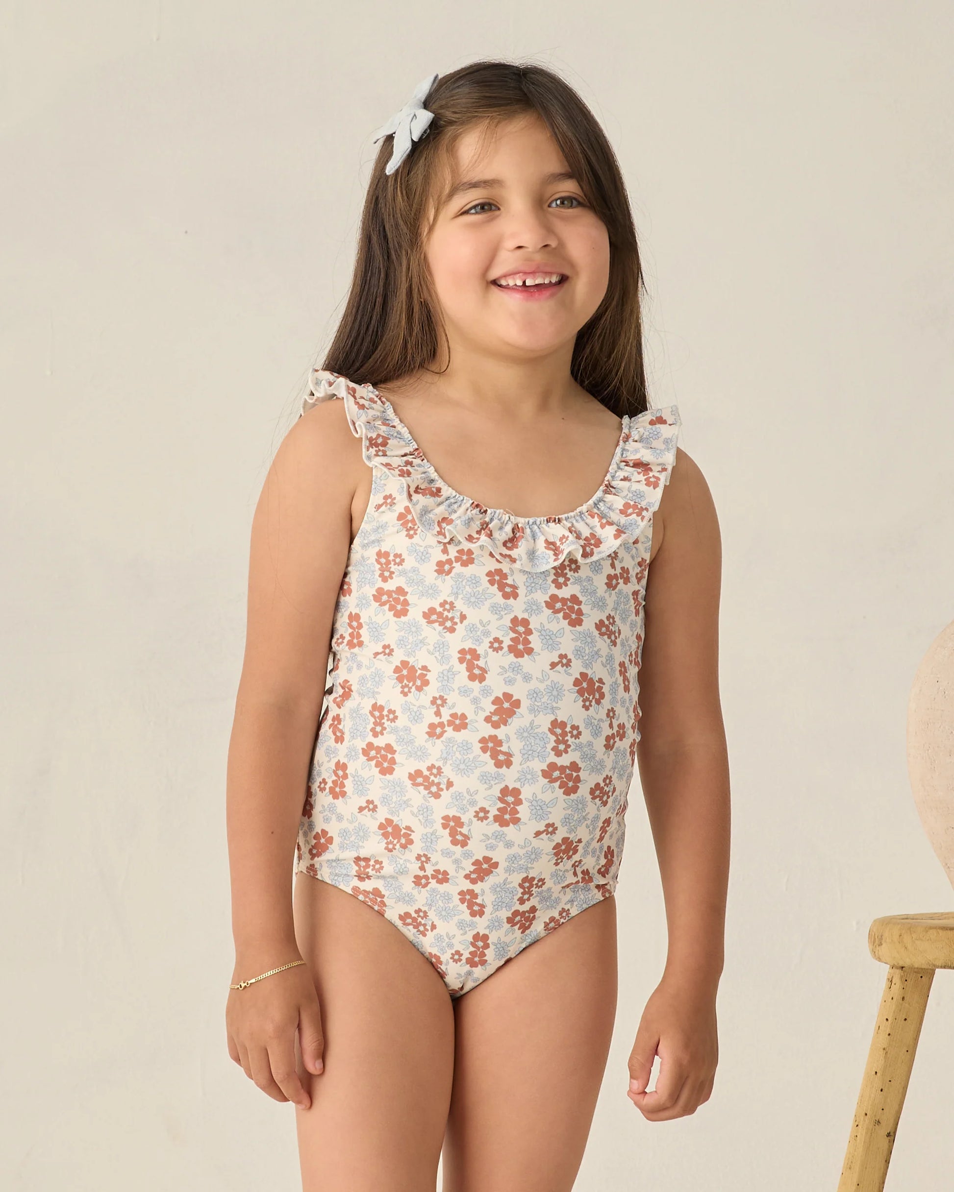 Rylee & Cru Americana Floral Giana one-piece swimsuit with colorful floral pattern and adjustable straps on a mannequin.