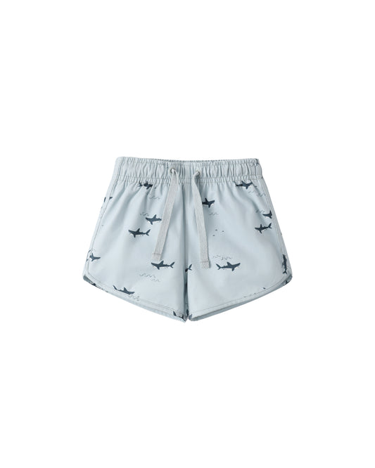 Light blue Sharks swim trunk by Rylee & Cru featuring a shark print, suitable for boys' swimwear, displayed flat on a white background.