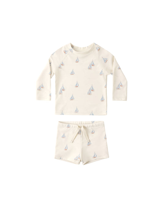 Rylee & Cru Sail Boys Rashguard Set featuring natural-colored long sleeve rashguards with sailboat print for sun protection and play.