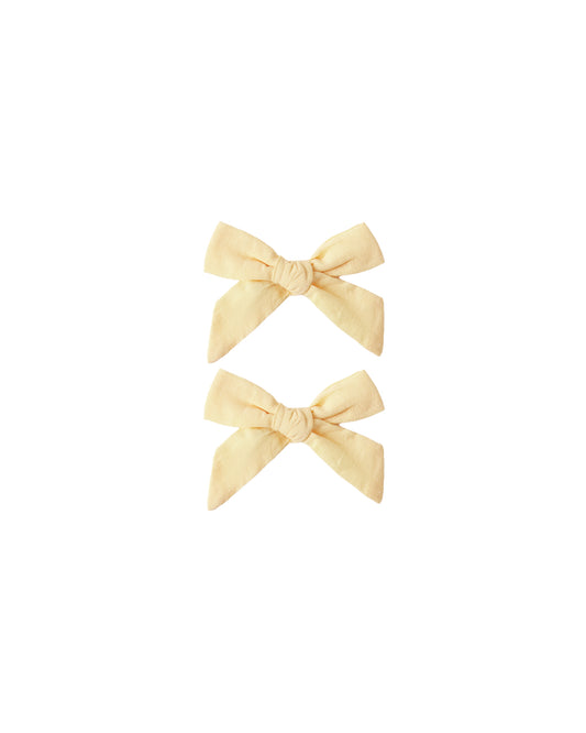 Set of two Rylee & Cru Lemon Bows featuring bright yellow lemon patterns on fabric hair accessories.