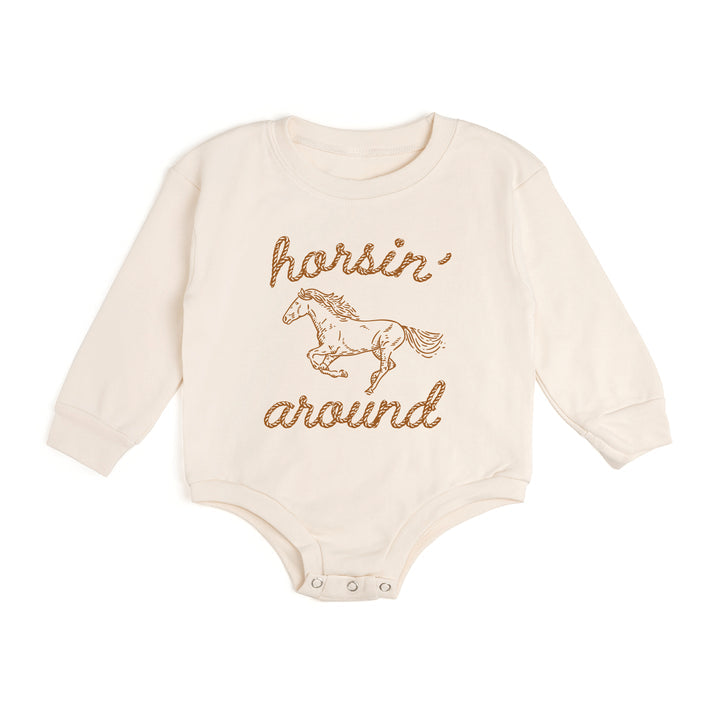 Sweet Wink Horsin' Around Western long sleeve romper for kids, featuring playful horse and western print fabric.