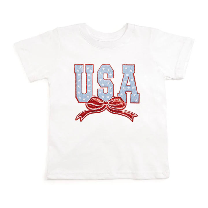 White short sleeve T-shirt by Sweet Wink featuring USA stars and bow patch design on the front.