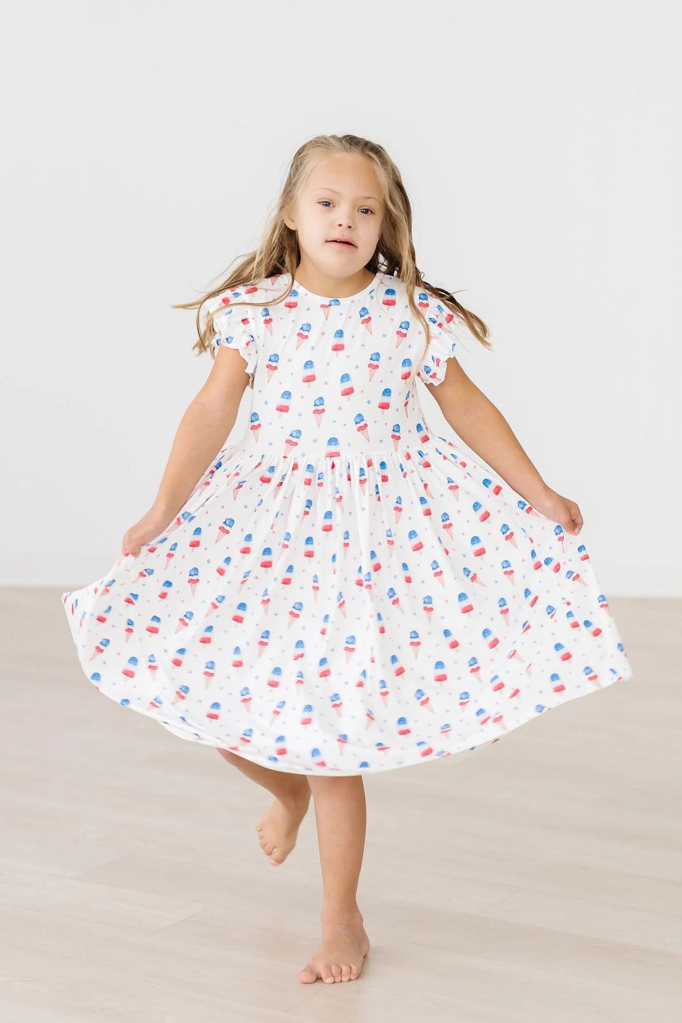 Mila & Rose Summer Sweets flutter sleeve twirl dress with pastel floral pattern and lightweight fabric for warm weather.