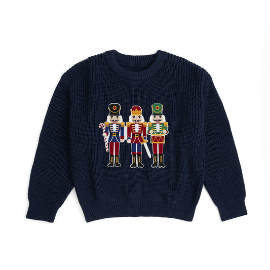 Sweet Wink Nutcracker Patch Christmas sweater featuring festive nutcracker embroidery on cozy knit fabric.