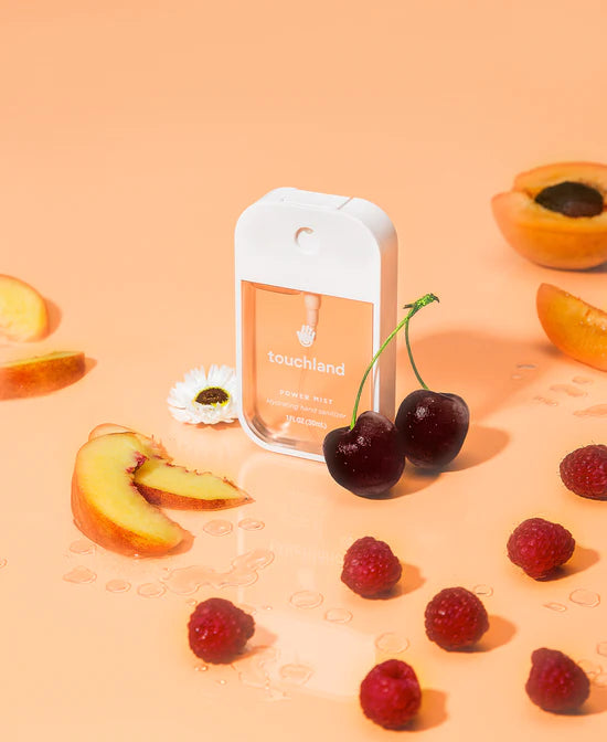 Touchland Powermists in Velvet Peach, a refreshing hand sanitizer spray with a sleek design and peach scent.