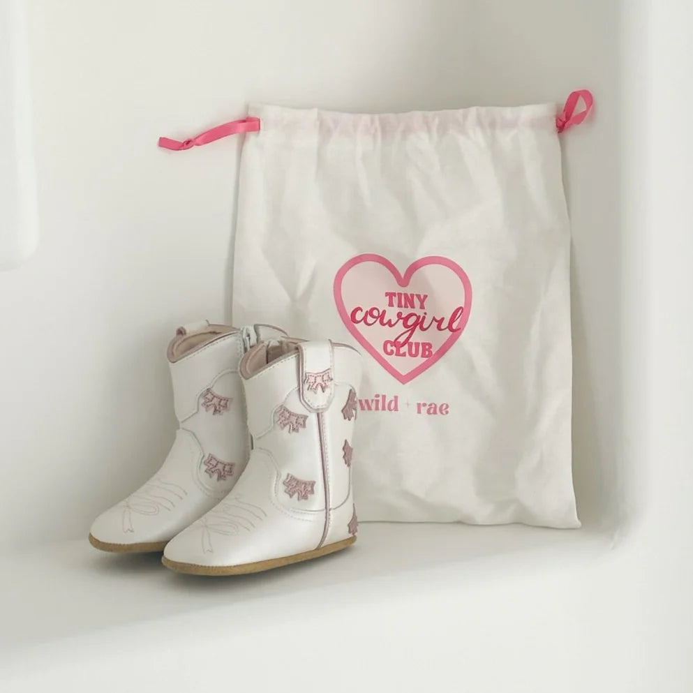 Wild + Rae cowgirl bow baby bootie with cute bow detail, soft fabric, and comfortable fit for infants.