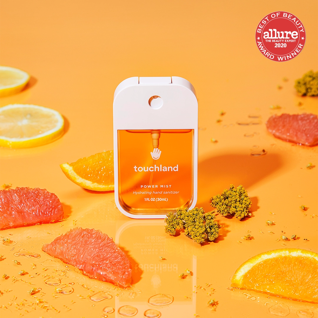 Touchland Powermists hand sanitizer spray with sleek design and clear label, providing portable sanitizing solution.