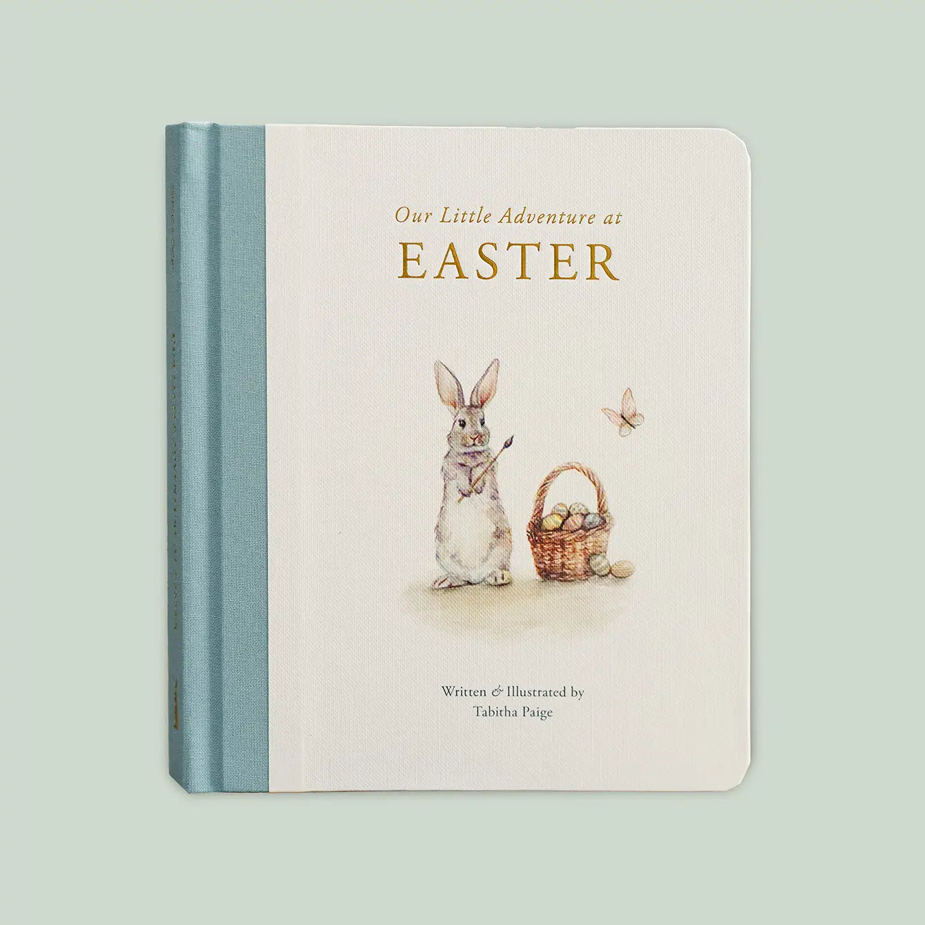 Open children's book titled "Our Little Adventure At Easter" by Paige Tate & Co., featuring colorful illustrations.