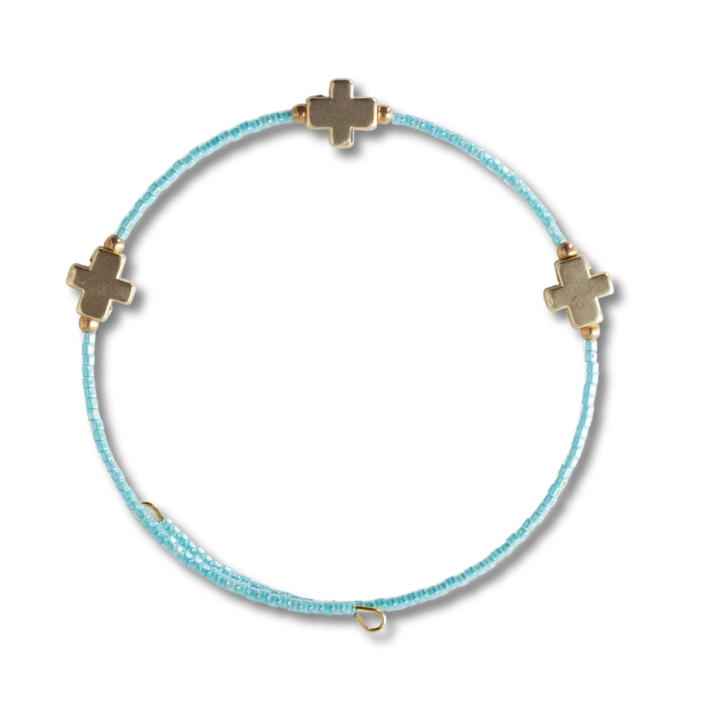 Lenny & Eva Faithful Bangles set featuring elegant gold-toned metal bracelets with intricate designs and a sleek finish.
