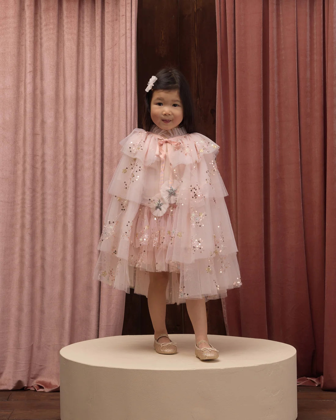 Pink tulle cape by Noralee featuring soft, flowing fabric with delicate layers and a stylish, elegant design.