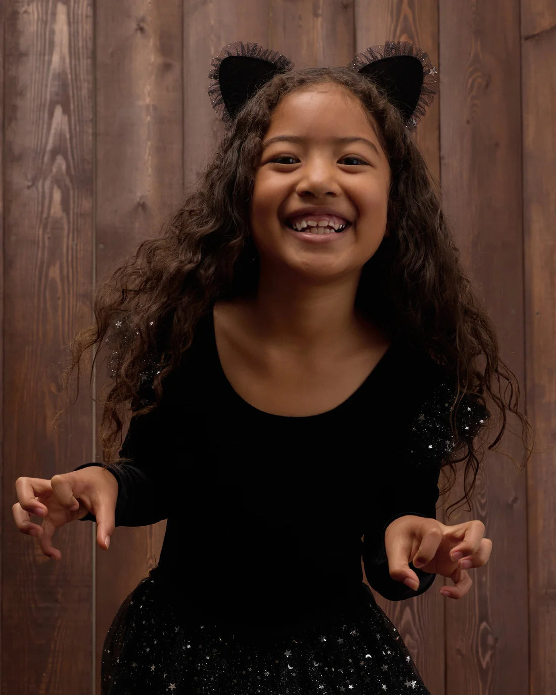 Noralee black cat headband with feline ears and bow, perfect for costume or casual wear, showcasing playful and stylish accessories.
