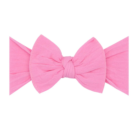 Bubblegum pink Baby Bling Bows knot nylon headband featuring a soft, stretchy design for babies and toddlers.