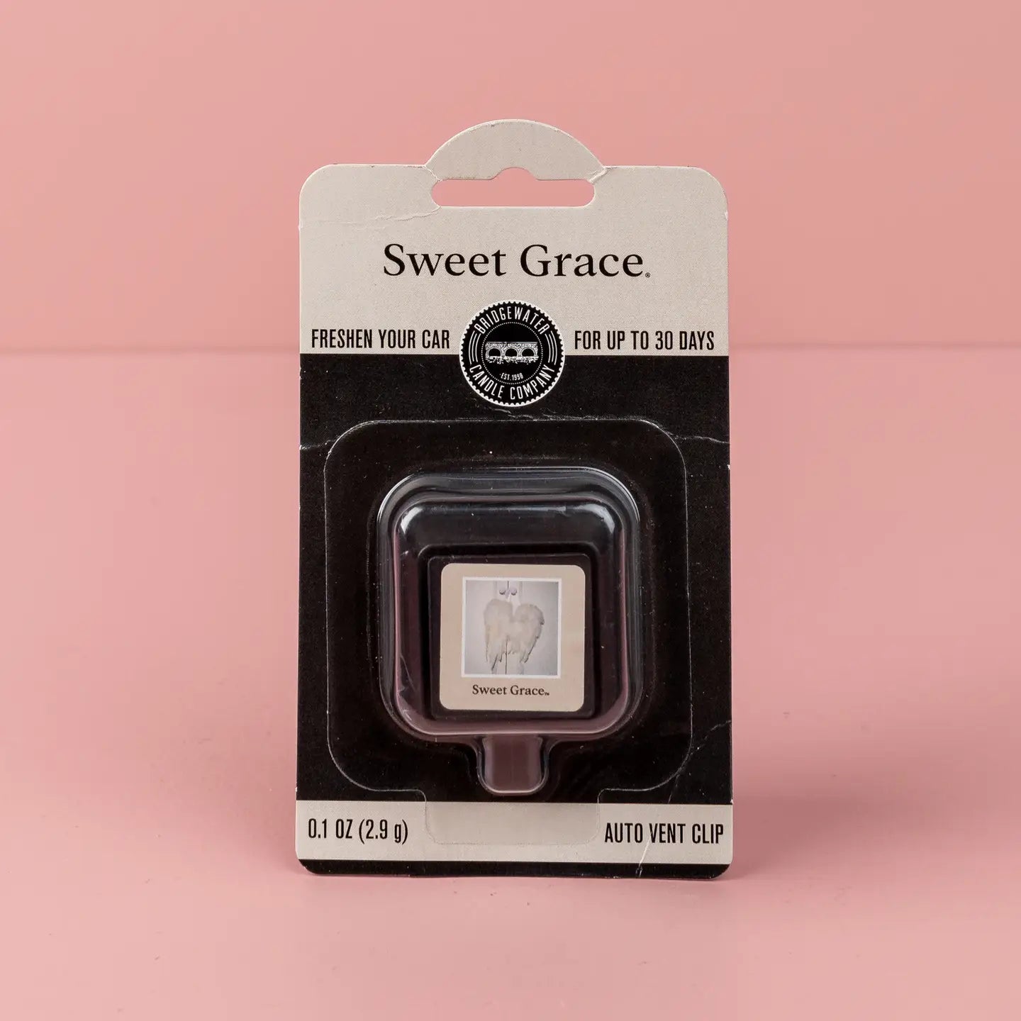 Bridgewater Candle Company Sweet Grace auto vent clip with floral design, shown clipped onto a car air vent.