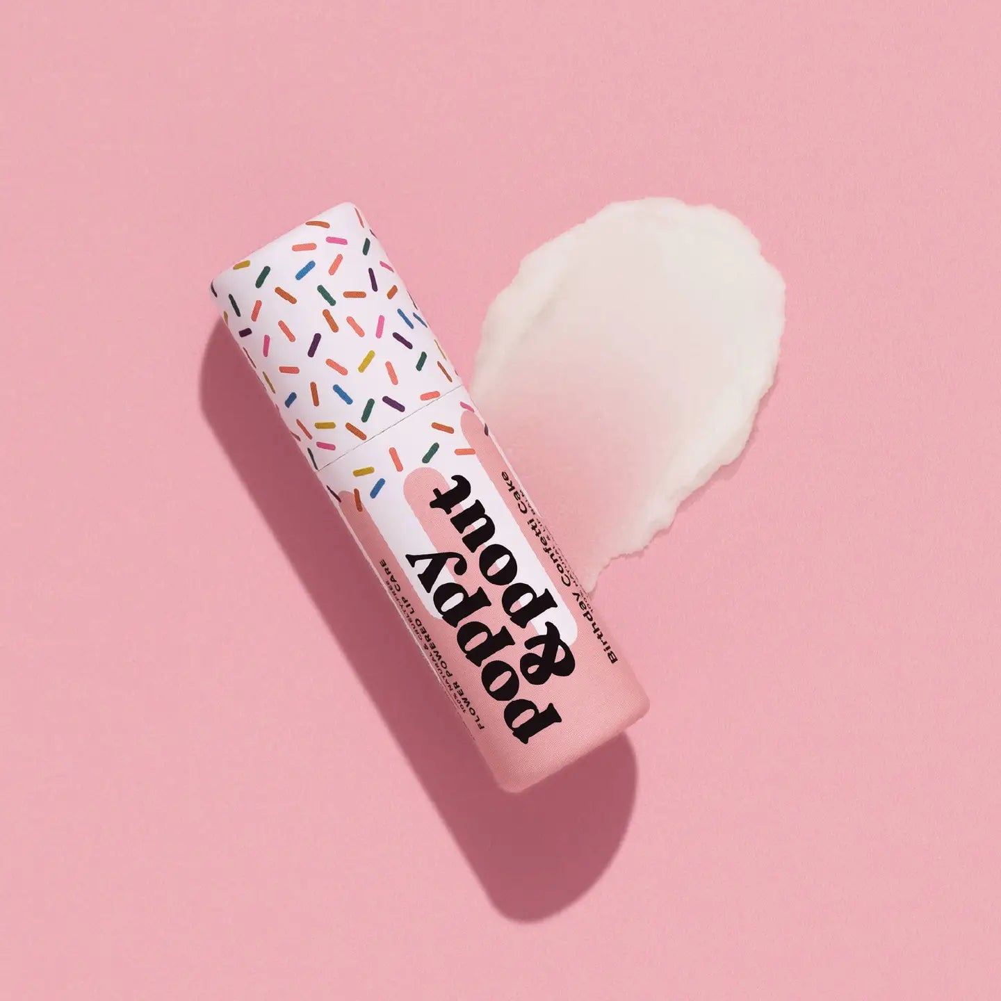 Sweet E's children's boutique Poppy & Pout lip balm in a colorful container, designed for kids' gentle lip care.
