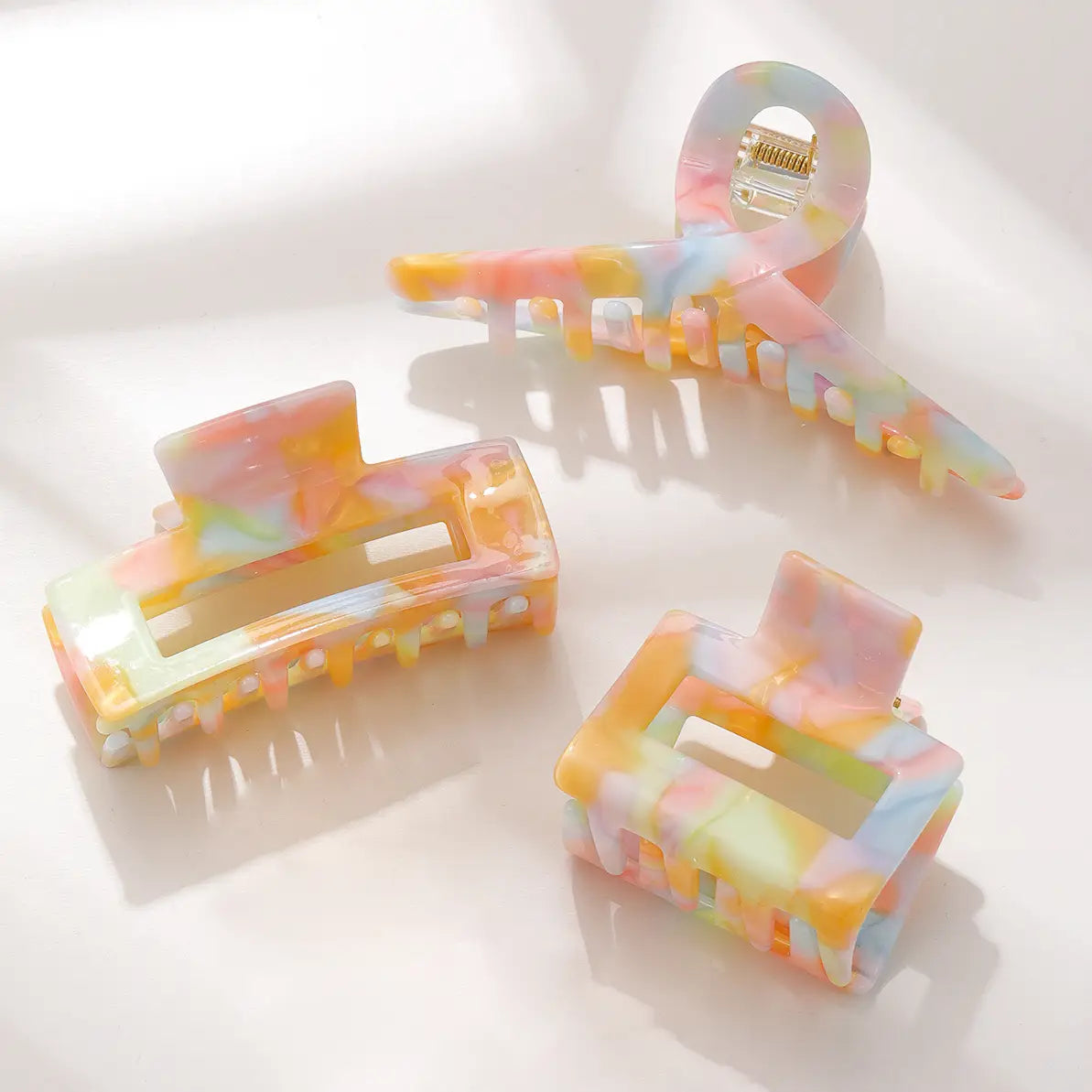 Pastel watercolor hair clip for children with soft pink, blue, and purple shades, featuring a delicate floral design.
