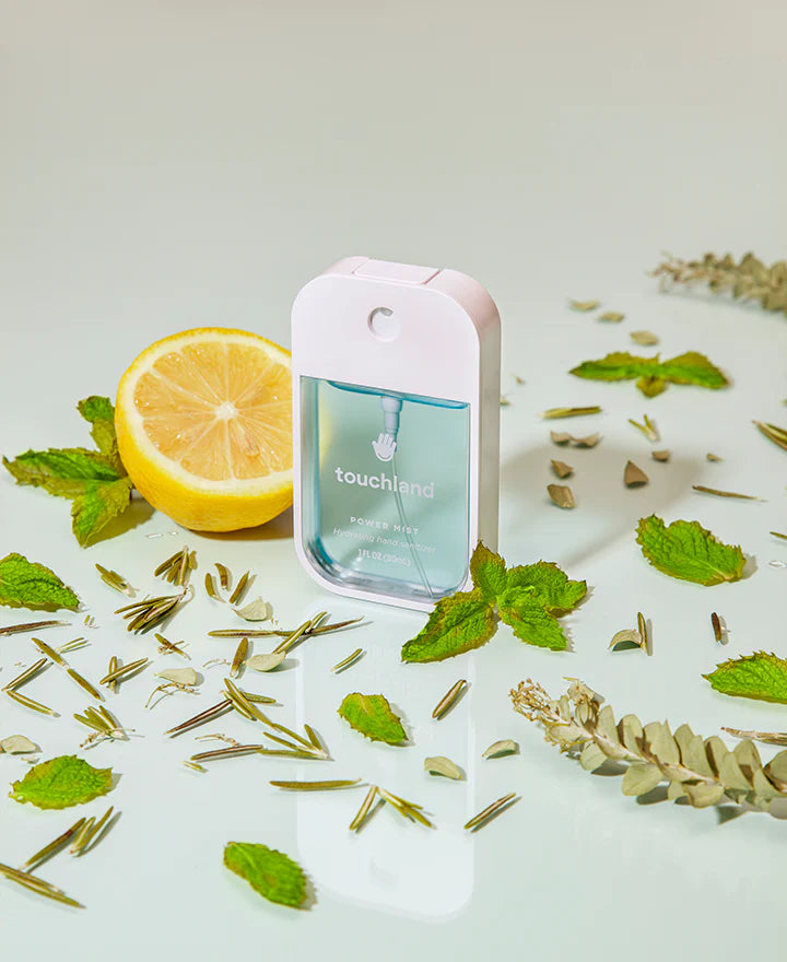 Touchland Powermists hand sanitizer spray with frosted mint scent, featuring a sleek transparent bottle and mint-colored mist.