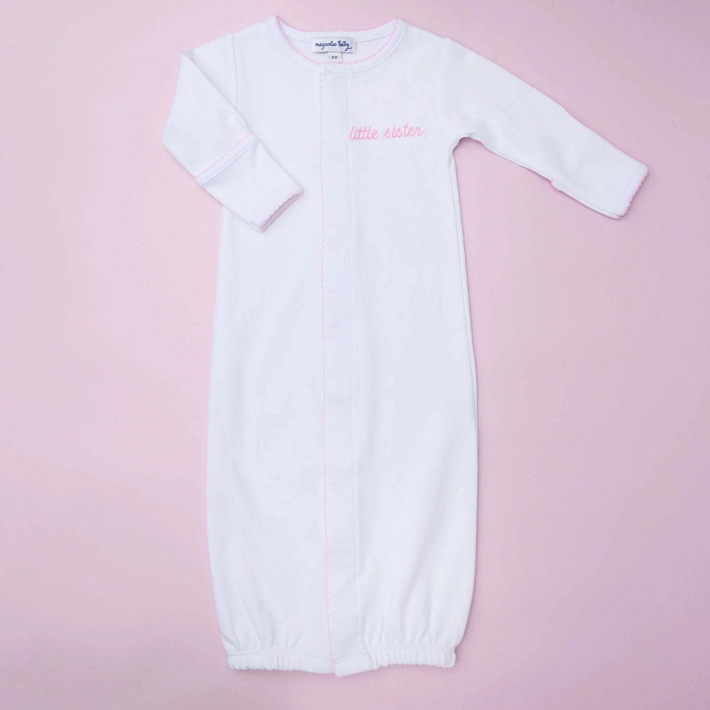 Magnolia Baby Little Sister embroidered converter, soft fabric with embroidered "Little Sister" text, for baby clothing or accessories.
