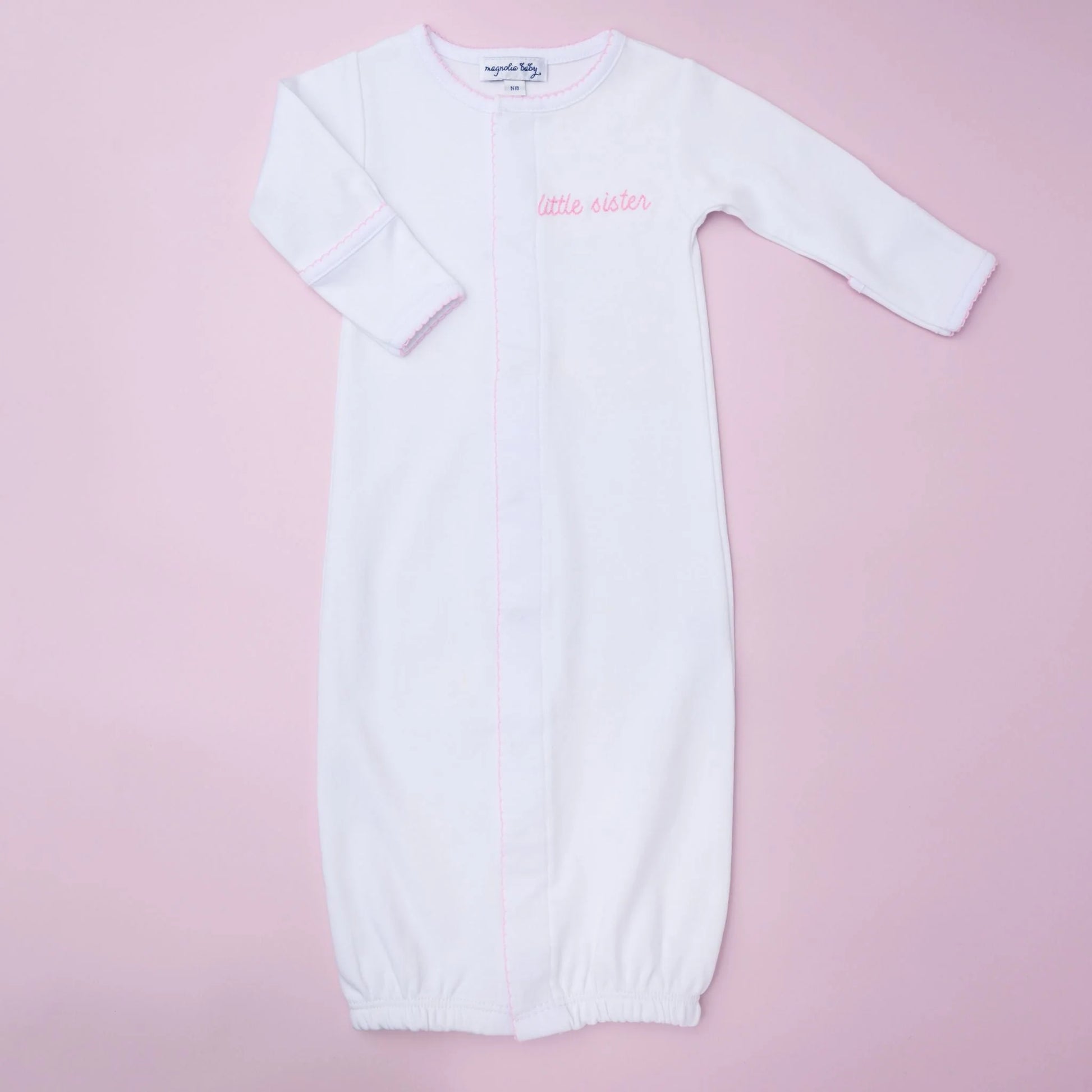 Magnolia Baby Little Sister embroidered converter, soft fabric with embroidered "Little Sister" text, for baby clothing or accessories.